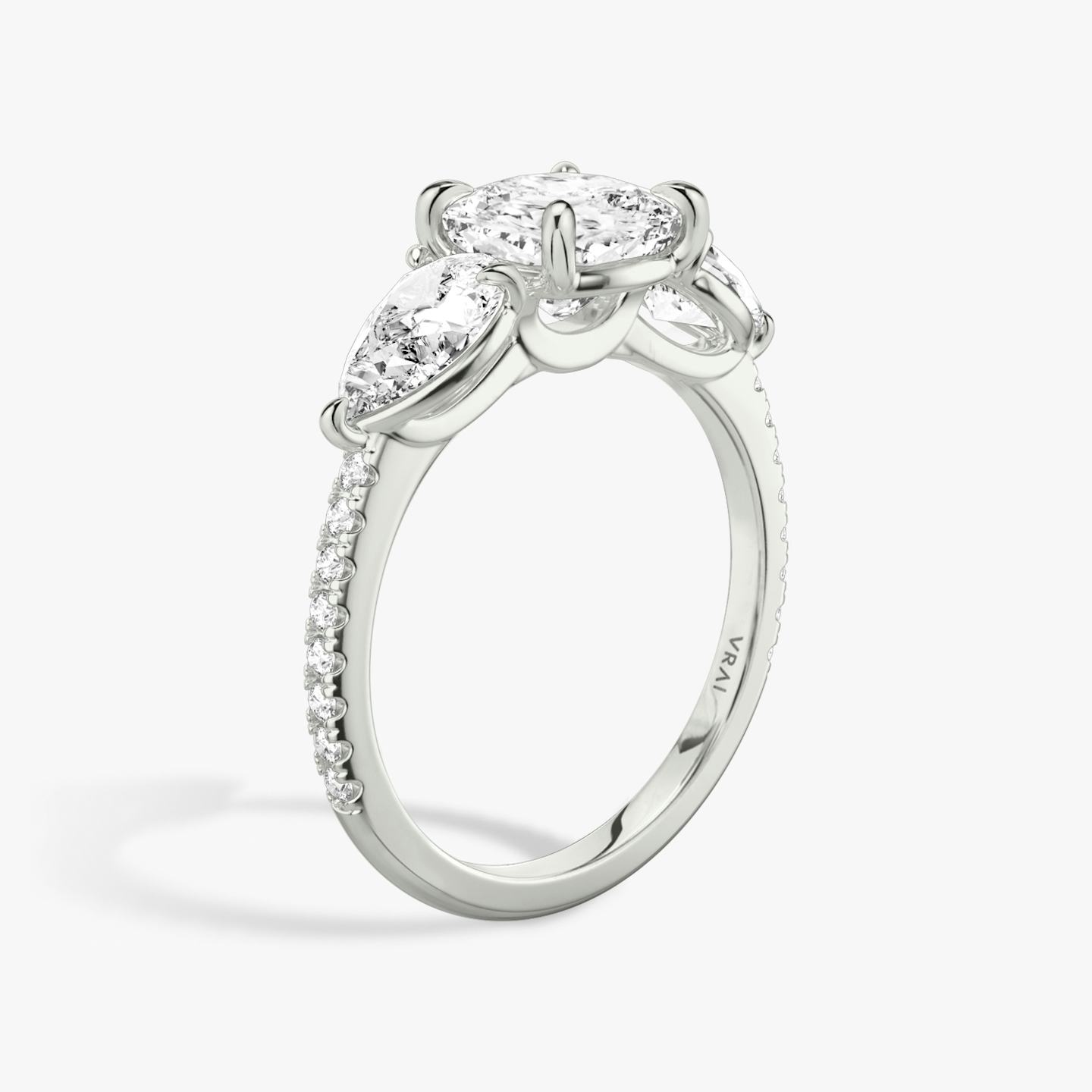 The Three Stone | Pavé Cushion | Platinum | Band: Pavé | Side stone carat: 1/2 | Side stone shape: Pear | Diamond orientation: vertical | Carat weight: See full inventory
