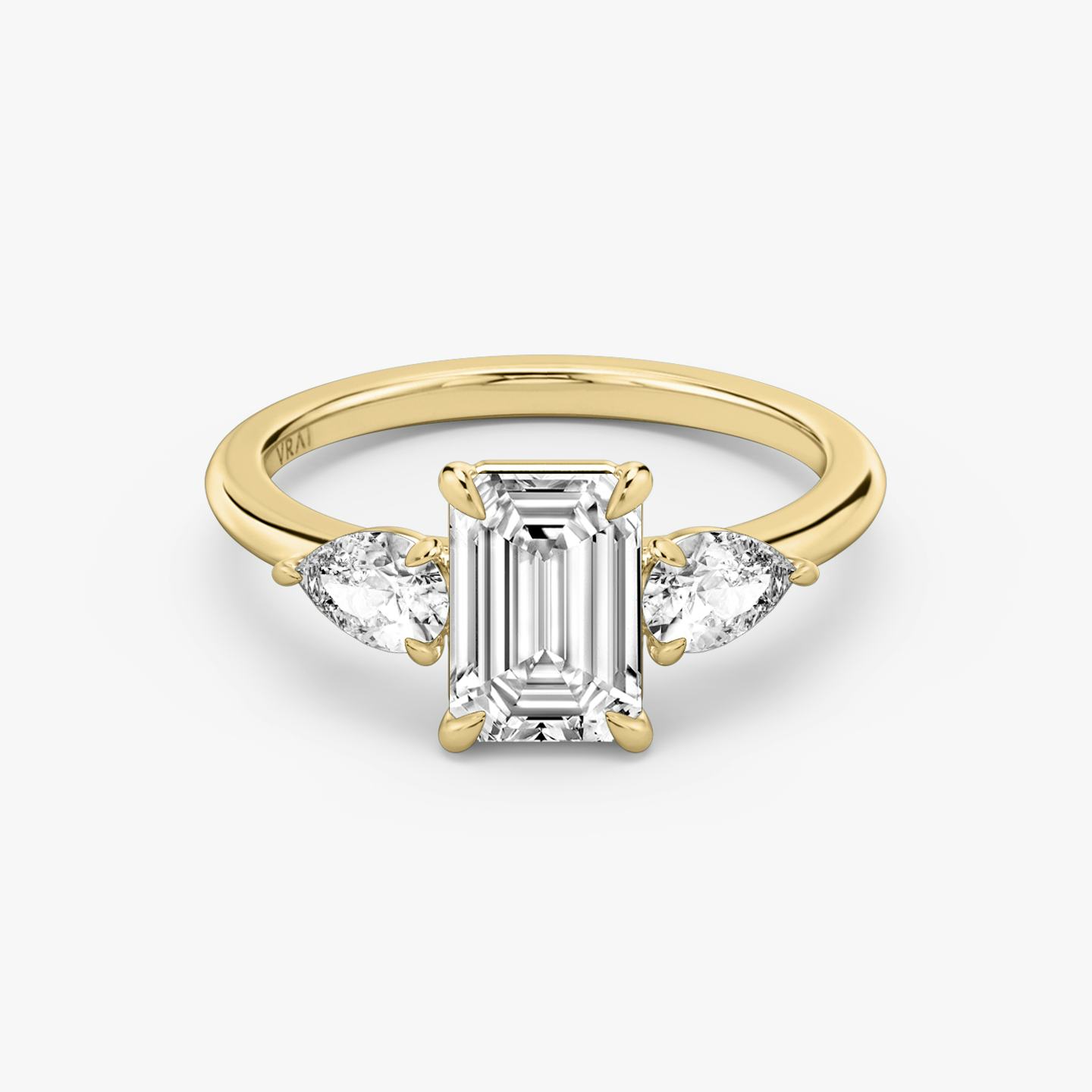 The Three Stone | Emerald | 18k | 18k Yellow Gold | Band: Plain | Side stone carat: 1/4 | Side stone shape: Pear | Diamond orientation: vertical | Carat weight: See full inventory