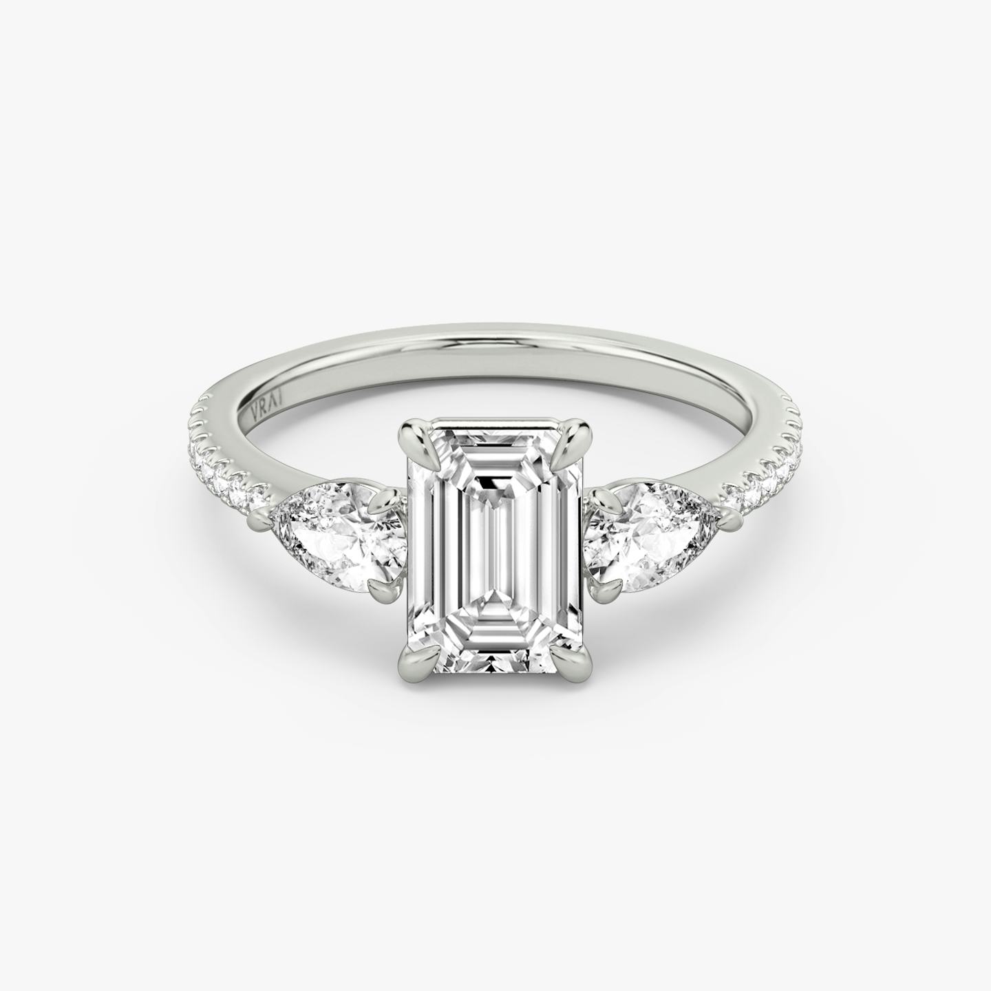 The Three Stone | Emerald | Platinum | Band: Pavé | Side stone carat: 1/4 | Side stone shape: Pear | Diamond orientation: vertical | Carat weight: See full inventory