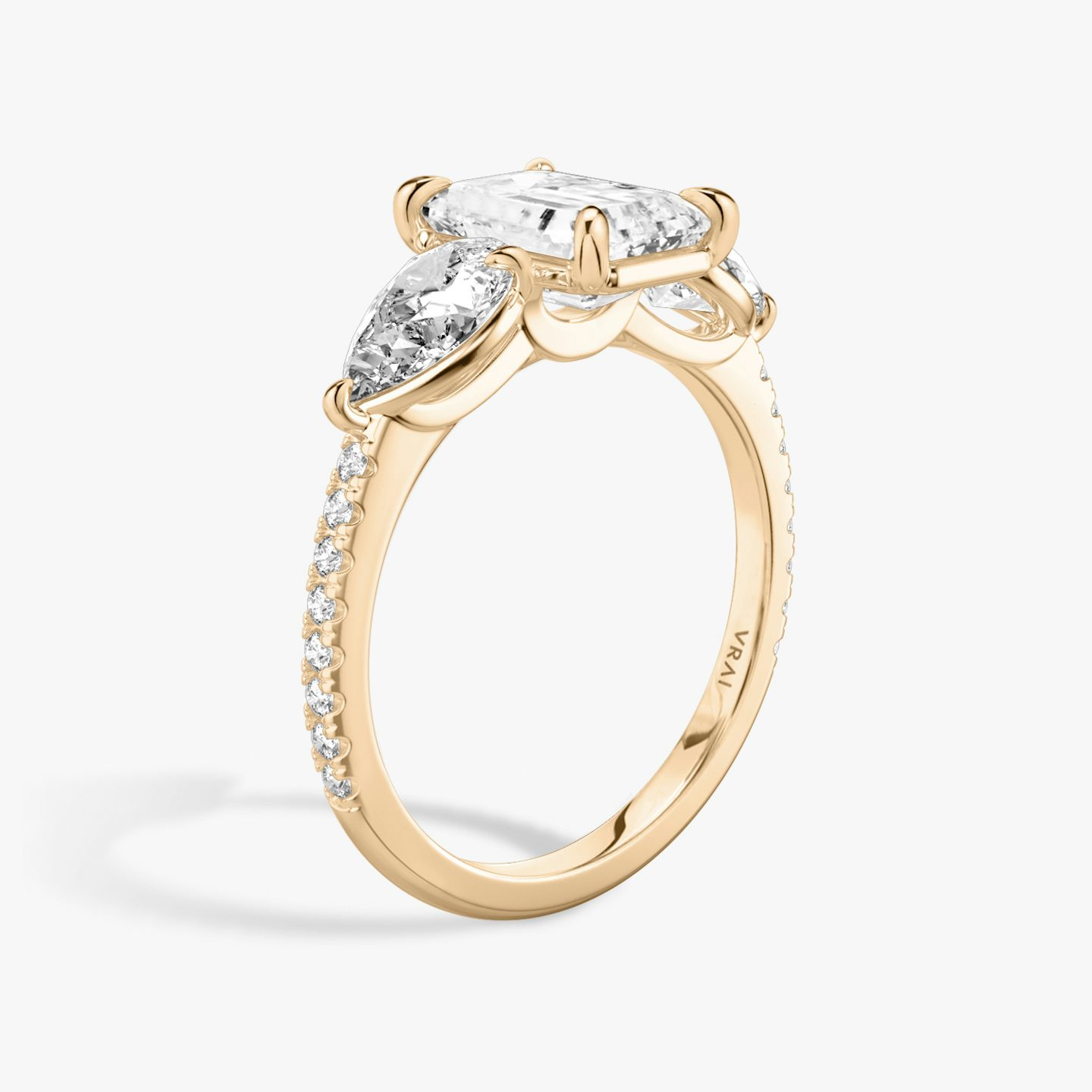 The Three Stone | Emerald | 14k | 14k Rose Gold | Band: Pavé | Side stone carat: 1/2 | Side stone shape: Pear | Diamond orientation: vertical | Carat weight: See full inventory