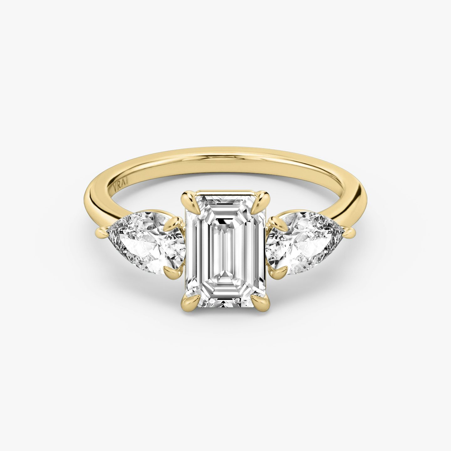 The Three Stone | Emerald | 18k | 18k Yellow Gold | Band: Plain | Side stone carat: 1/2 | Side stone shape: Pear | Diamond orientation: vertical | Carat weight: See full inventory