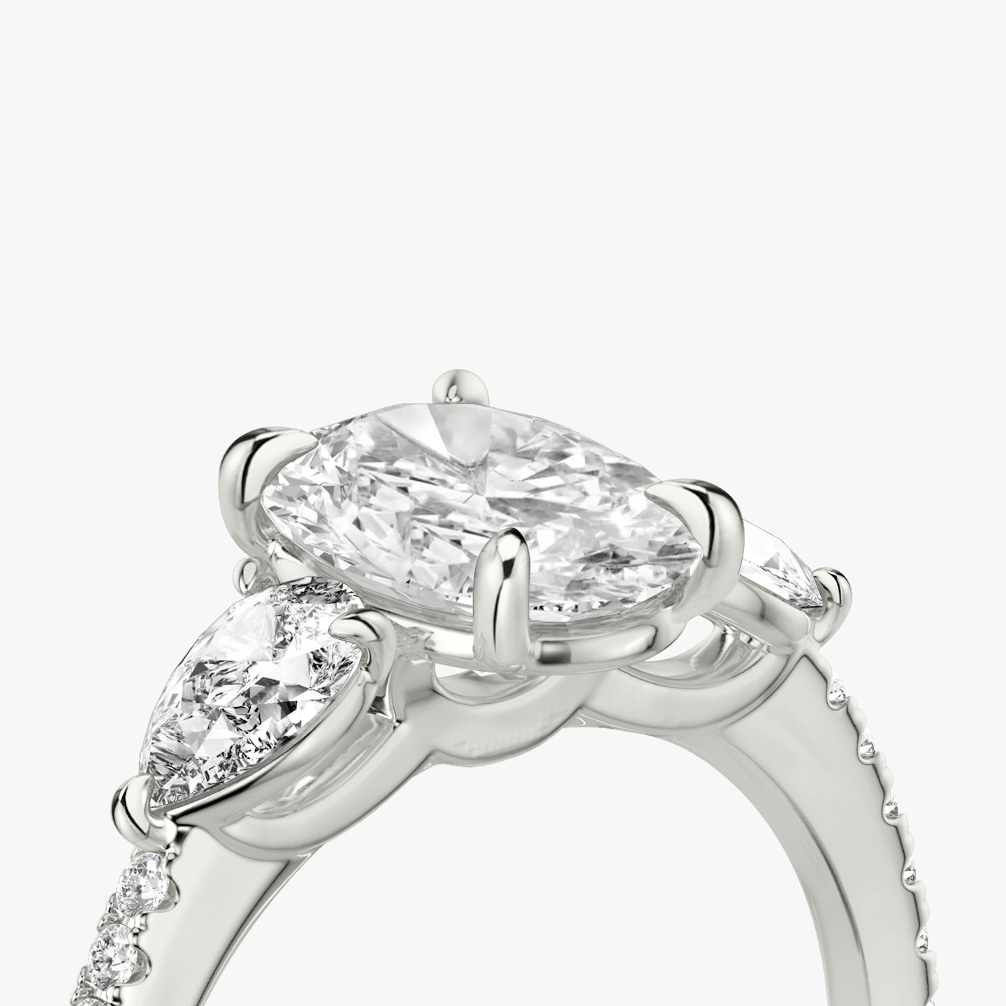 The Three Stone | Oval | 18k | 18k White Gold | Band: Pavé | Side stone carat: 1/4 | Side stone shape: Pear | Diamond orientation: vertical | Carat weight: See full inventory