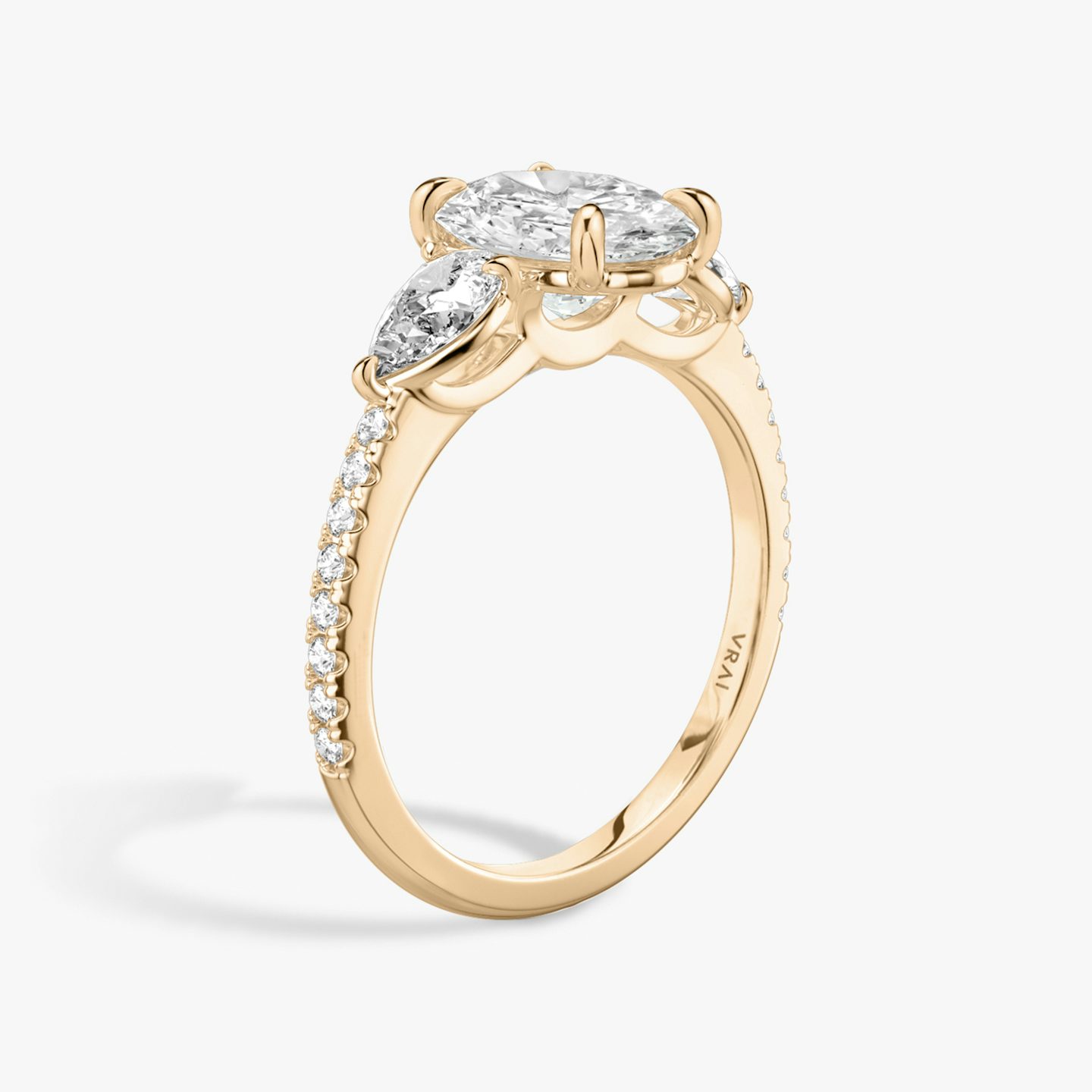 The Three Stone | Oval | 14k | 14k Rose Gold | Band: Pavé | Side stone carat: 1/4 | Side stone shape: Pear | Diamond orientation: vertical | Carat weight: See full inventory