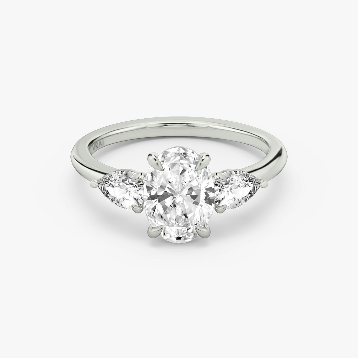 The Three Stone | Oval | 18k | 18k White Gold | Band: Plain | Side stone carat: 1/4 | Side stone shape: Pear | Diamond orientation: vertical | Carat weight: See full inventory