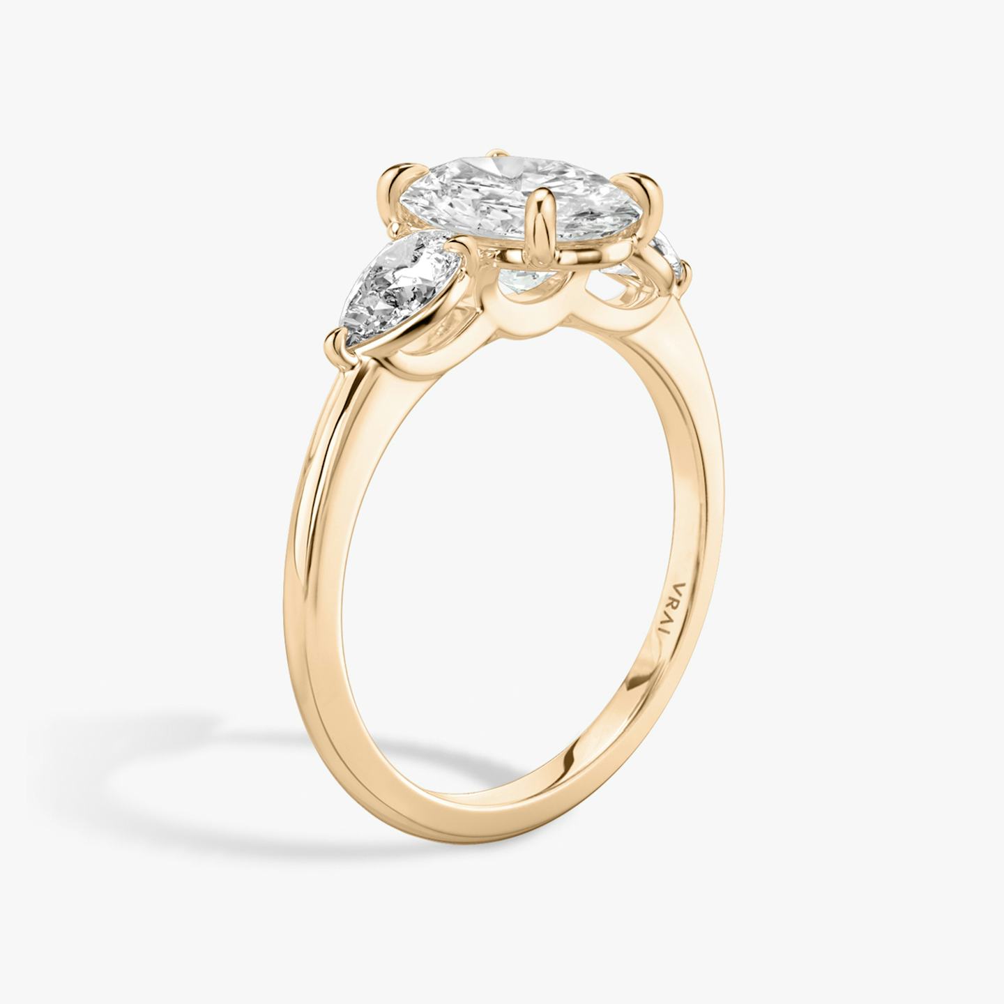 The Three Stone | Oval | 14k | 14k Rose Gold | Band: Plain | Side stone carat: 1/4 | Side stone shape: Pear | Diamond orientation: vertical | Carat weight: See full inventory