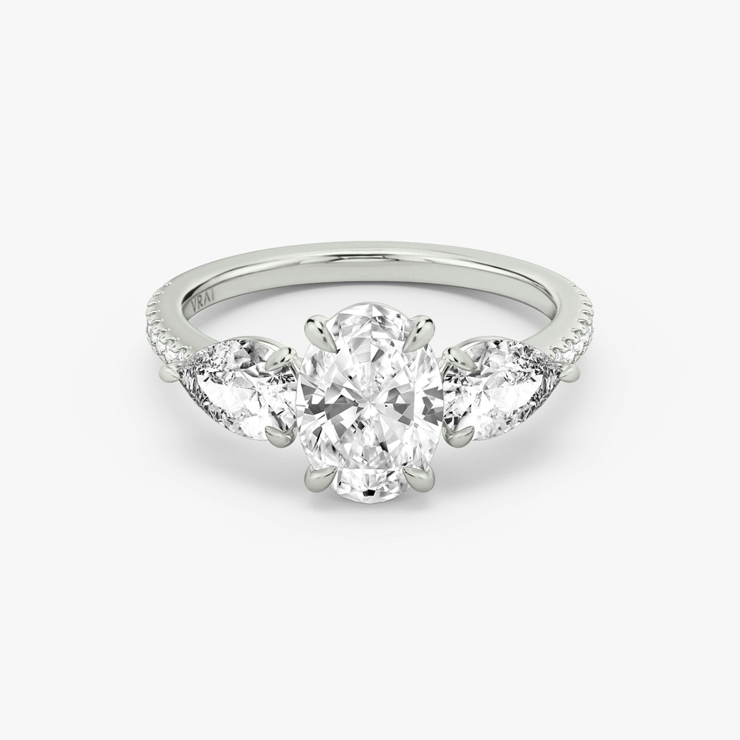 The Three Stone | Oval | 18k | 18k White Gold | Band: Pavé | Side stone carat: 1/2 | Side stone shape: Pear | Diamond orientation: vertical | Carat weight: See full inventory