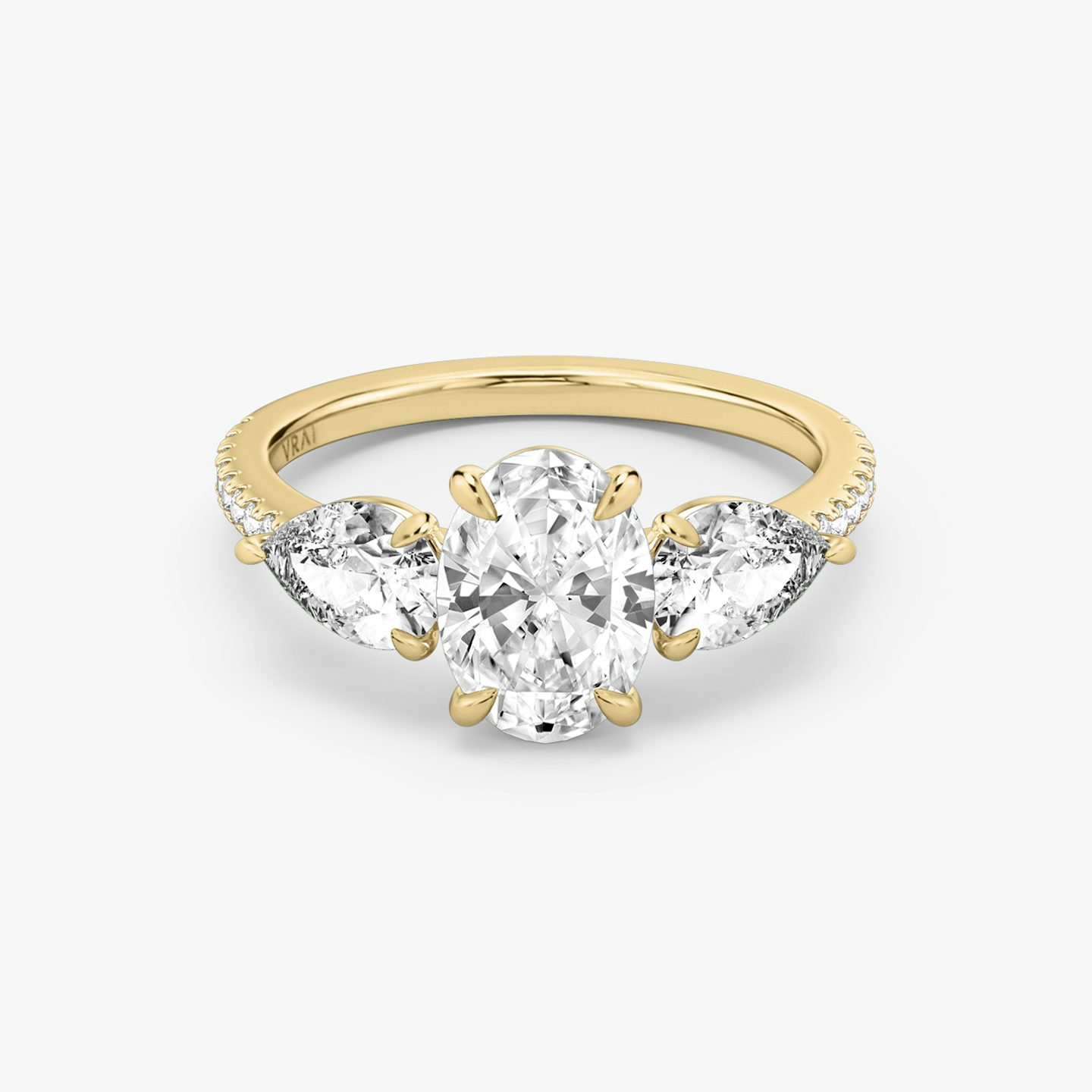 The Three Stone | Oval | 18k | 18k Yellow Gold | Band: Pavé | Side stone carat: 1/2 | Side stone shape: Pear | Diamond orientation: vertical | Carat weight: See full inventory