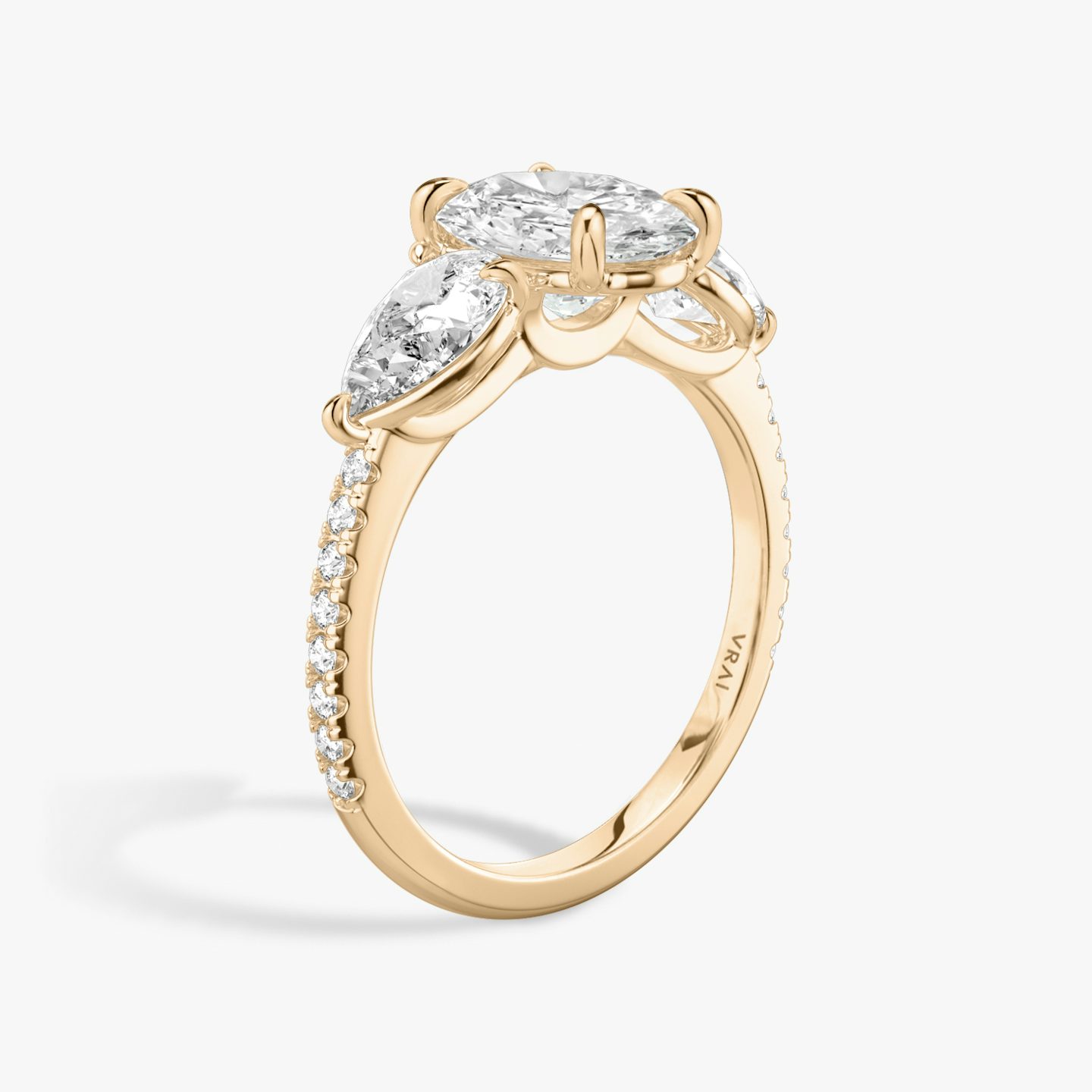 The Three Stone | Oval | 14k | 14k Rose Gold | Band: Pavé | Side stone carat: 1/2 | Side stone shape: Pear | Diamond orientation: vertical | Carat weight: See full inventory