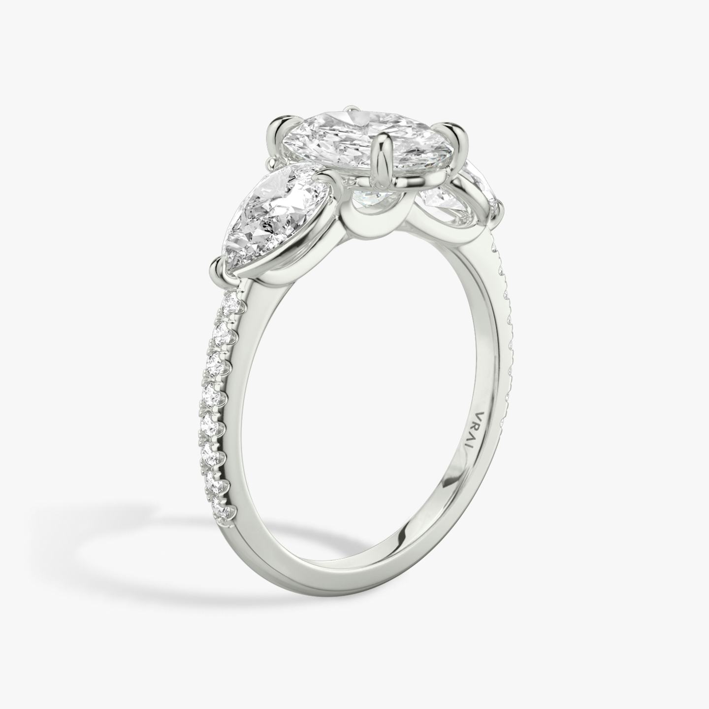 The Three Stone | Oval | Platinum | Band: Pavé | Side stone carat: 1/2 | Side stone shape: Pear | Diamond orientation: vertical | Carat weight: See full inventory
