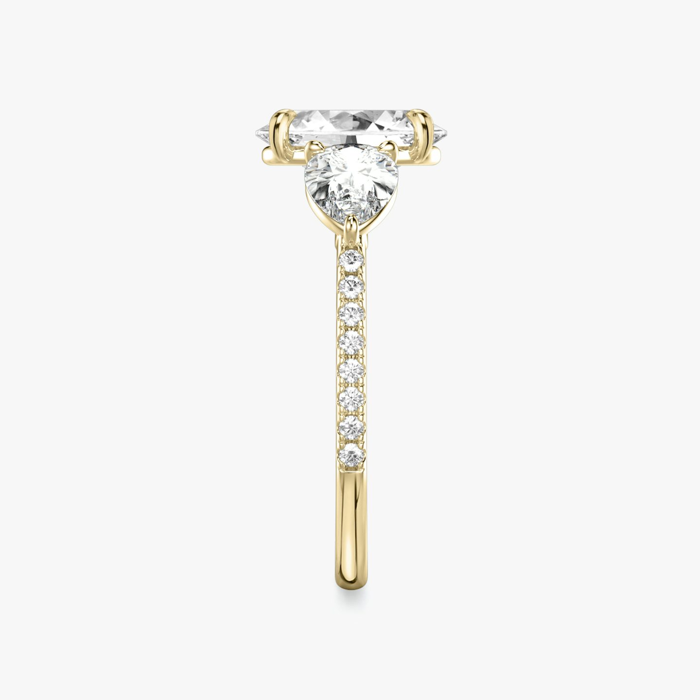 The Three Stone | Oval | 18k | 18k Yellow Gold | Band: Pavé | Side stone carat: 1/2 | Side stone shape: Pear | Diamond orientation: vertical | Carat weight: See full inventory