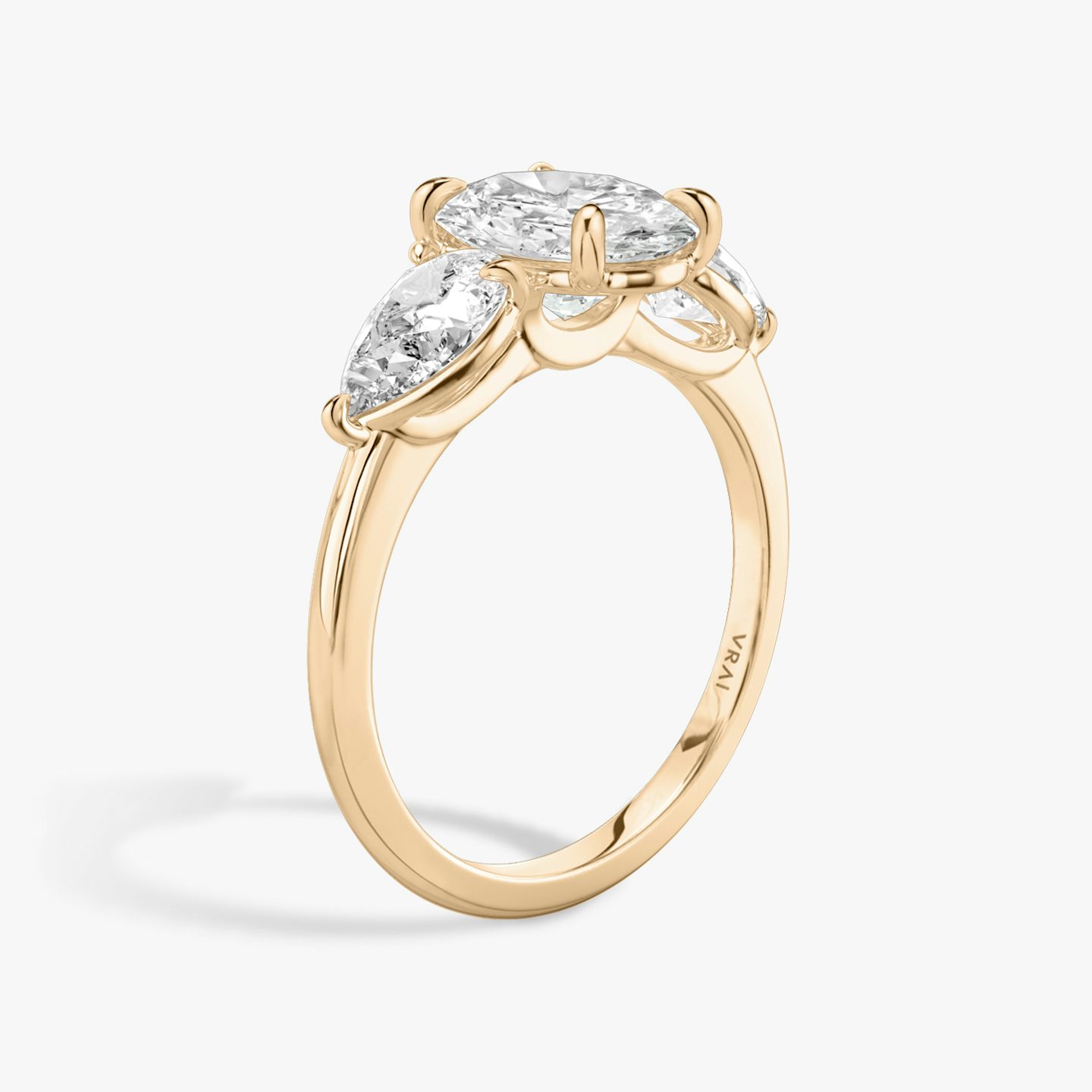The Three Stone | Oval | 14k | 14k Rose Gold | Band: Plain | Side stone carat: 1/2 | Side stone shape: Pear | Diamond orientation: vertical | Carat weight: See full inventory