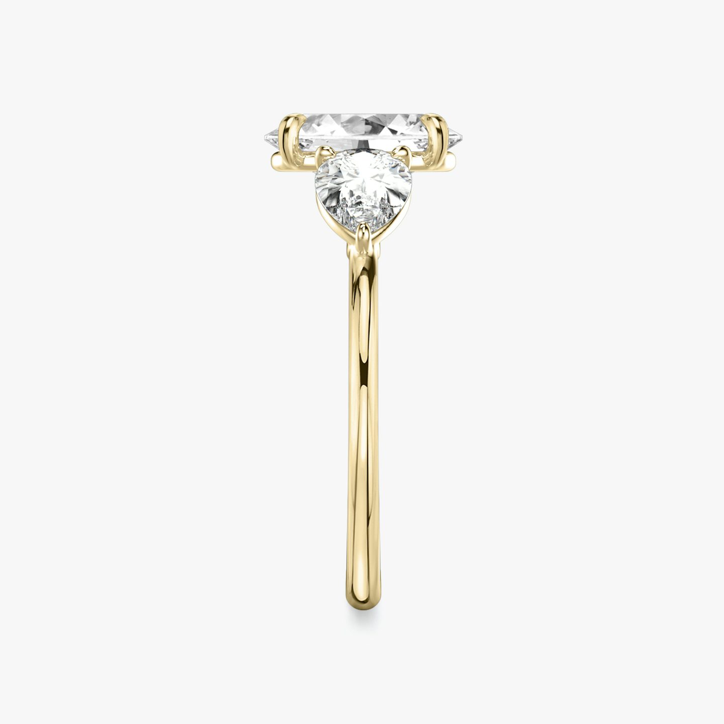 The Three Stone | Oval | 18k | 18k Yellow Gold | Band: Plain | Side stone carat: 1/2 | Side stone shape: Pear | Diamond orientation: vertical | Carat weight: See full inventory