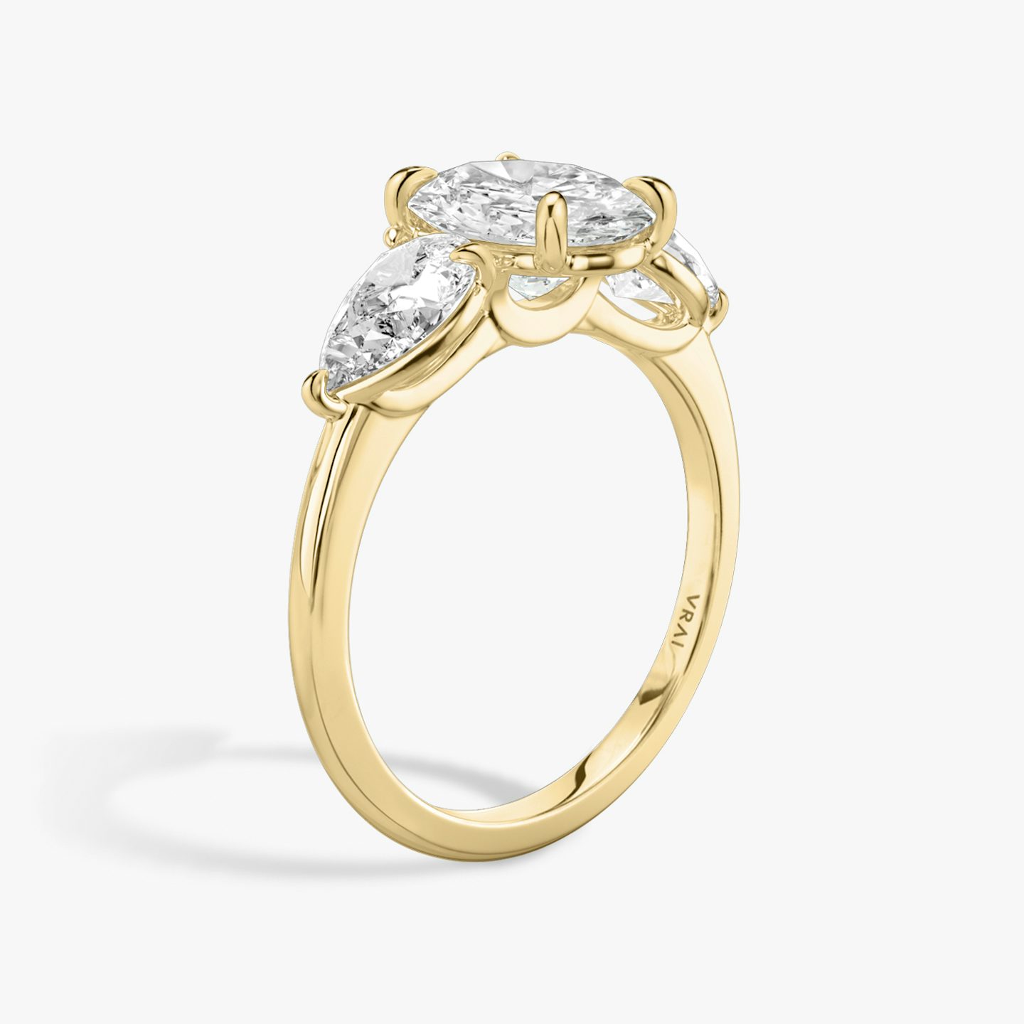 The Three Stone | Oval | 18k | 18k Yellow Gold | Band: Plain | Side stone carat: 1/2 | Side stone shape: Pear | Diamond orientation: vertical | Carat weight: See full inventory