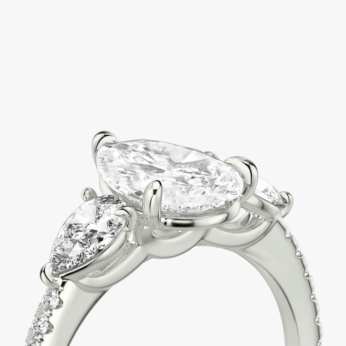 The Three Stone | Pear | 18k | 18k White Gold | Band: Pavé | Side stone carat: 1/4 | Side stone shape: Pear | Diamond orientation: vertical | Carat weight: See full inventory