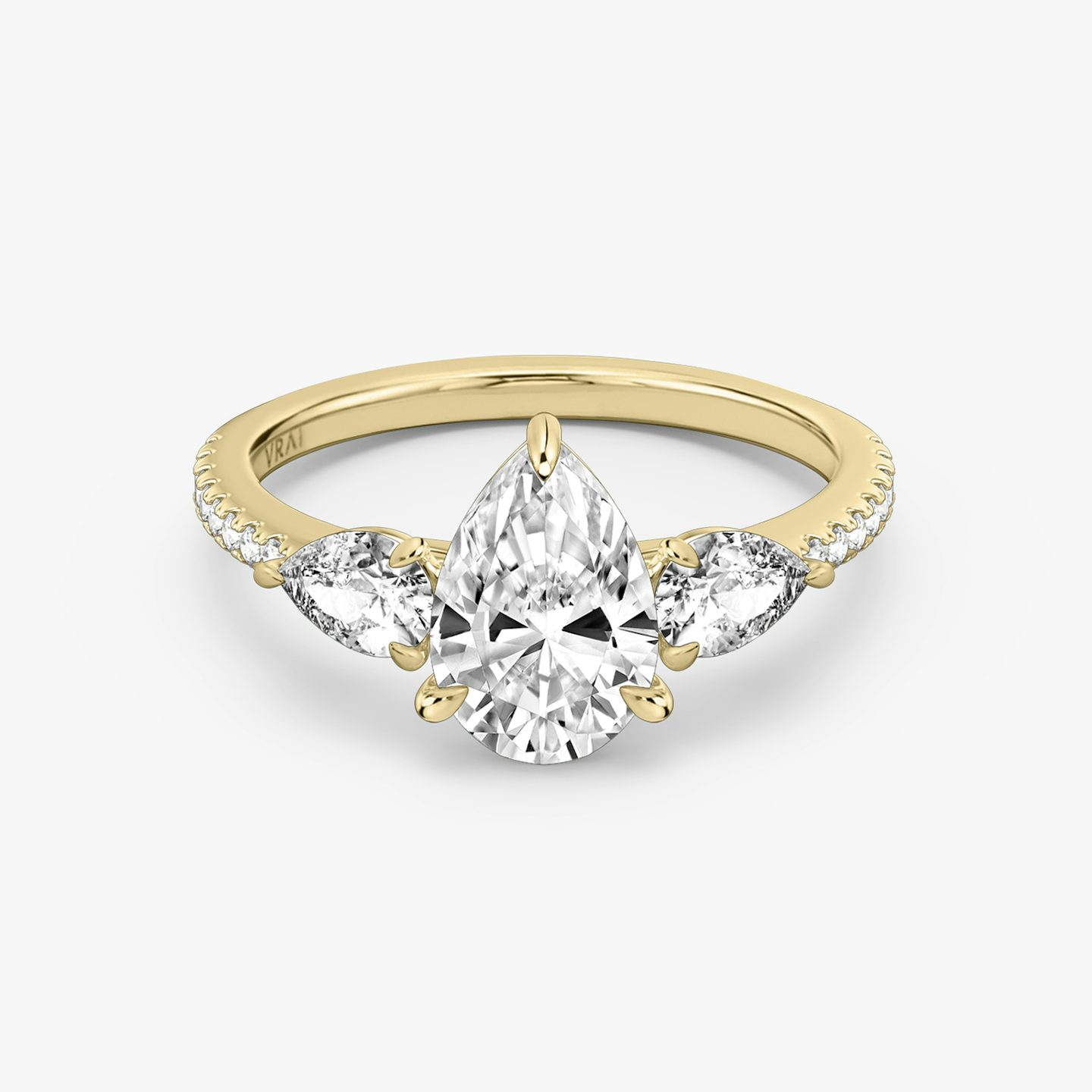 The Three Stone | Pear | 18k | 18k Yellow Gold | Band: Pavé | Side stone carat: 1/4 | Side stone shape: Pear | Diamond orientation: vertical | Carat weight: See full inventory