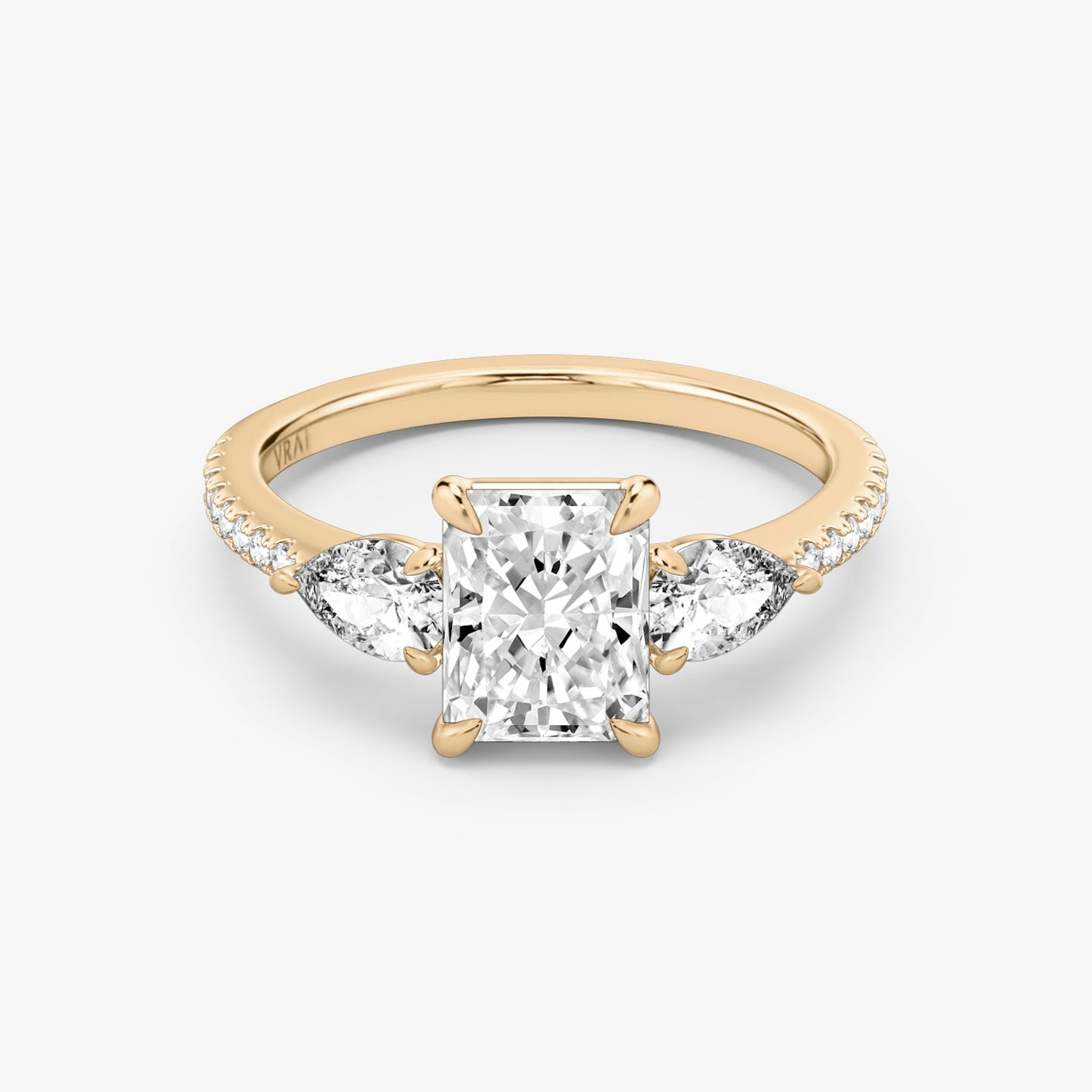 The Three Stone | Radiant | 14k | 14k Rose Gold | Band: Pavé | Side stone carat: 1/4 | Side stone shape: Pear | Diamond orientation: vertical | Carat weight: See full inventory