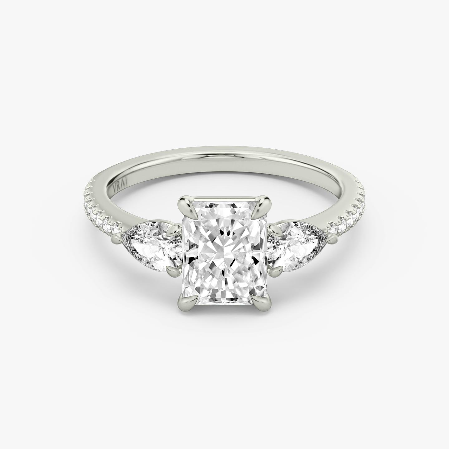 The Three Stone | Radiant | Platinum | Band: Pavé | Side stone carat: 1/4 | Side stone shape: Pear | Diamond orientation: vertical | Carat weight: See full inventory