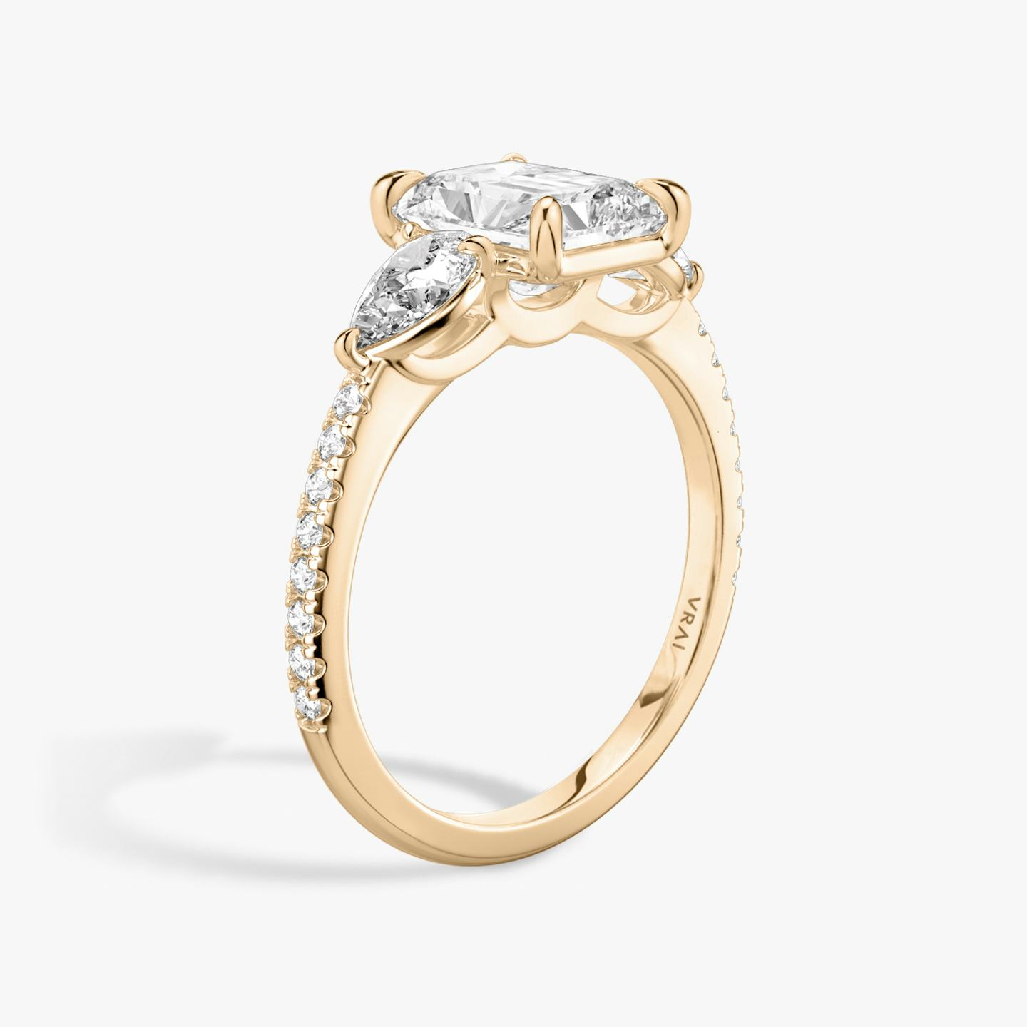 The Three Stone | Radiant | 14k | 14k Rose Gold | Band: Pavé | Side stone carat: 1/4 | Side stone shape: Pear | Diamond orientation: vertical | Carat weight: See full inventory