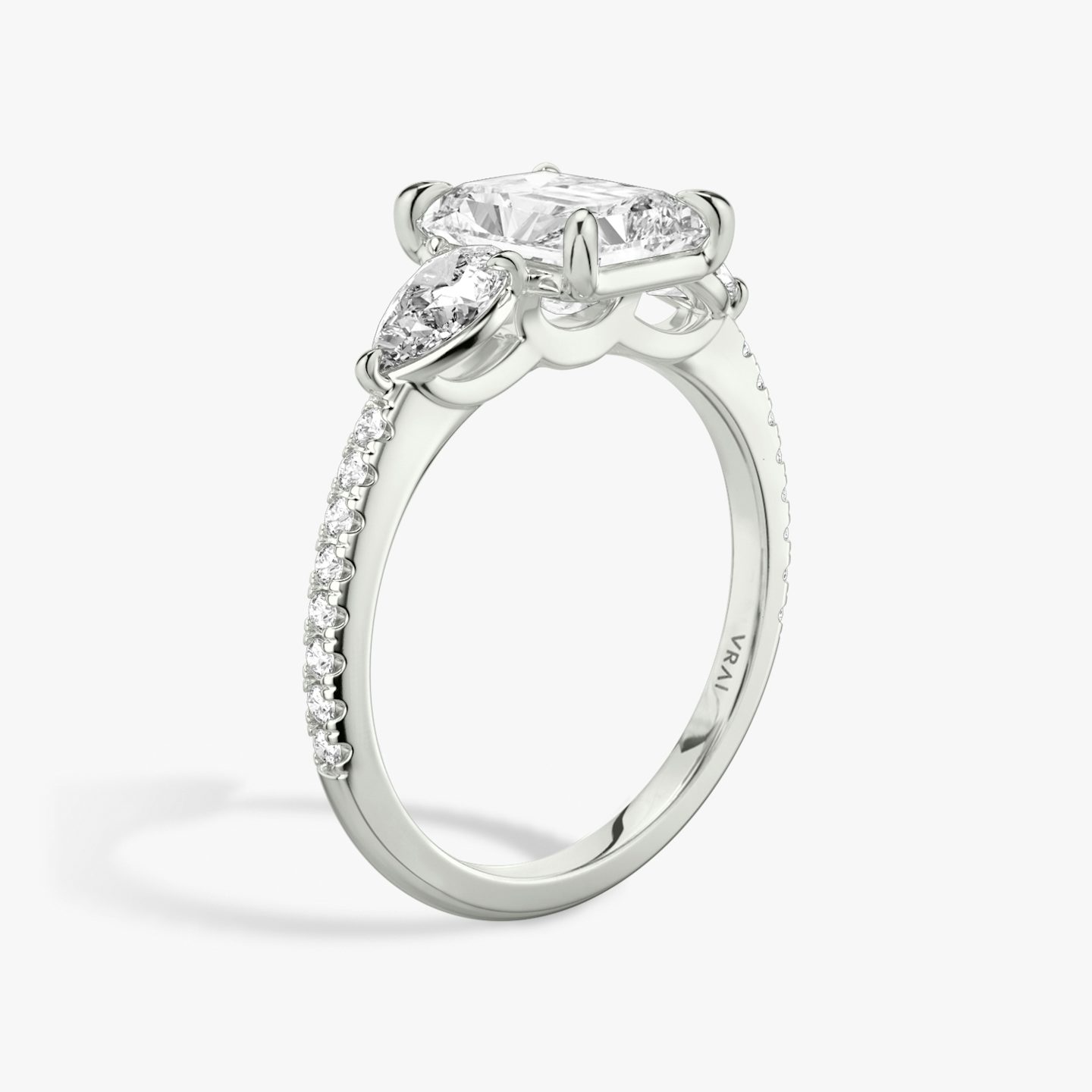 The Three Stone | Radiant | 18k | 18k White Gold | Band: Pavé | Side stone carat: 1/4 | Side stone shape: Pear | Diamond orientation: vertical | Carat weight: See full inventory