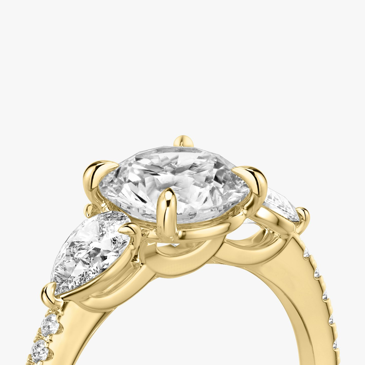 The Three Stone | Round Brilliant | 18k | 18k Yellow Gold | Band: Pavé | Carat weight: See full inventory | Side stone carat: 1/4 | Side stone shape: Pear | Diamond orientation: vertical