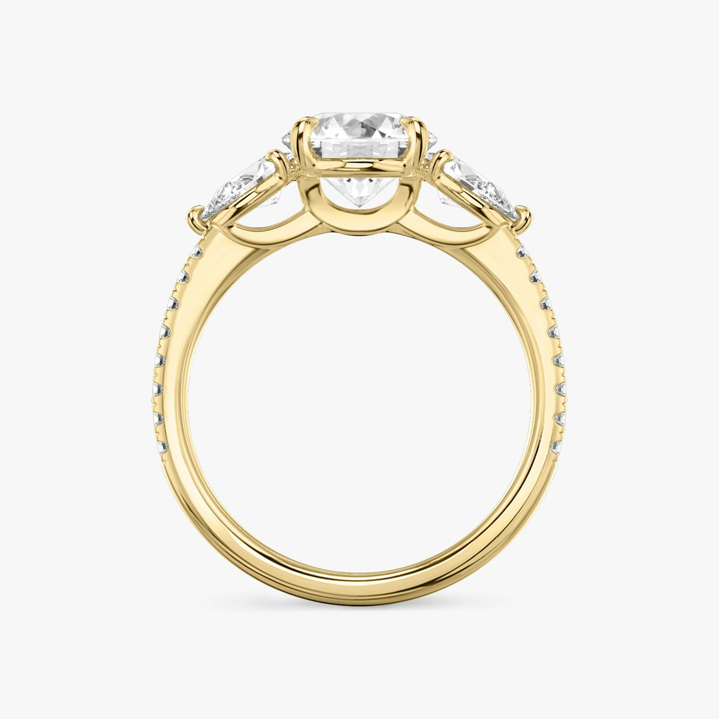 The Three Stone | Round Brilliant | 18k | 18k Yellow Gold | Band: Pavé | Carat weight: See full inventory | Side stone carat: 1/4 | Side stone shape: Pear | Diamond orientation: vertical
