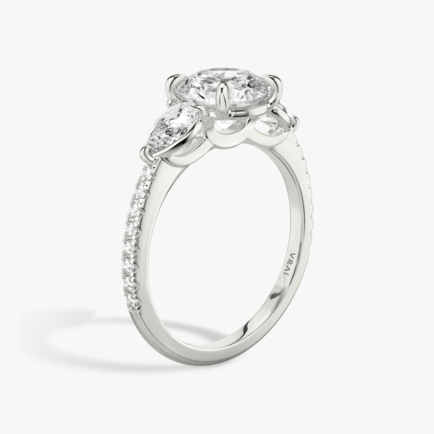 The Three Stone | Round Brilliant | Platinum | Band: Pavé | Carat weight: See full inventory | Side stone carat: 1/4 | Side stone shape: Pear | Diamond orientation: vertical