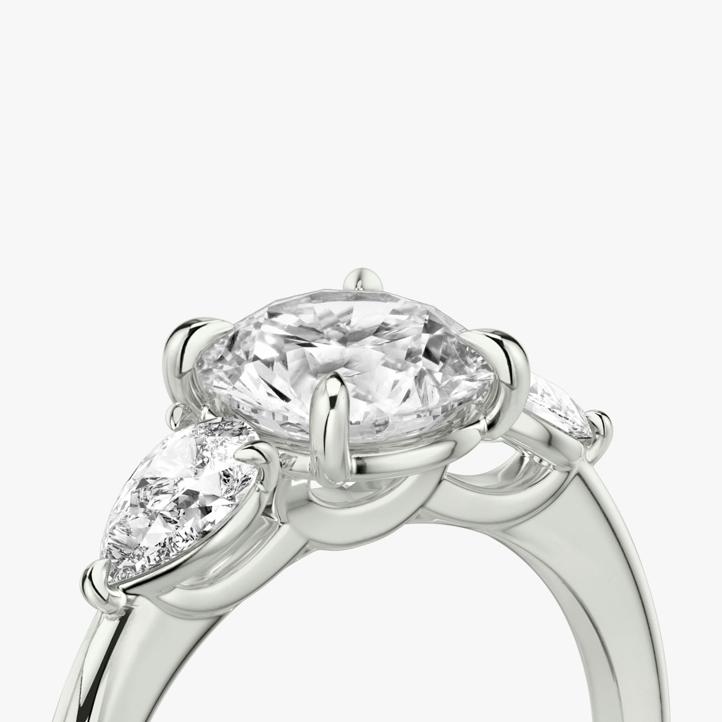 The Three Stone | Round Brilliant | 18k | 18k White Gold | Band: Plain | Carat weight: See full inventory | Side stone carat: 1/4 | Side stone shape: Pear | Diamond orientation: vertical