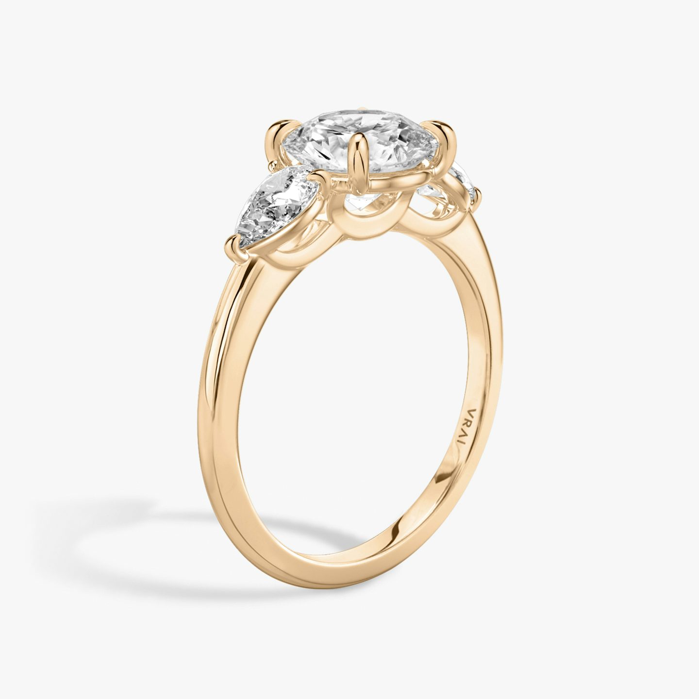 The Three Stone | Round Brilliant | 14k | 14k Rose Gold | Band: Plain | Carat weight: See full inventory | Side stone carat: 1/4 | Side stone shape: Pear | Diamond orientation: vertical