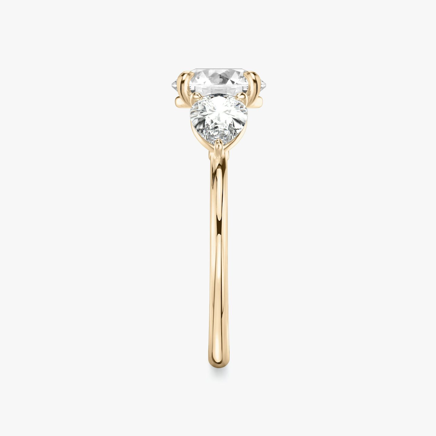 The Three Stone | Round Brilliant | 14k | 14k Rose Gold | Band: Plain | Carat weight: See full inventory | Side stone carat: 1/2 | Side stone shape: Pear | Diamond orientation: vertical