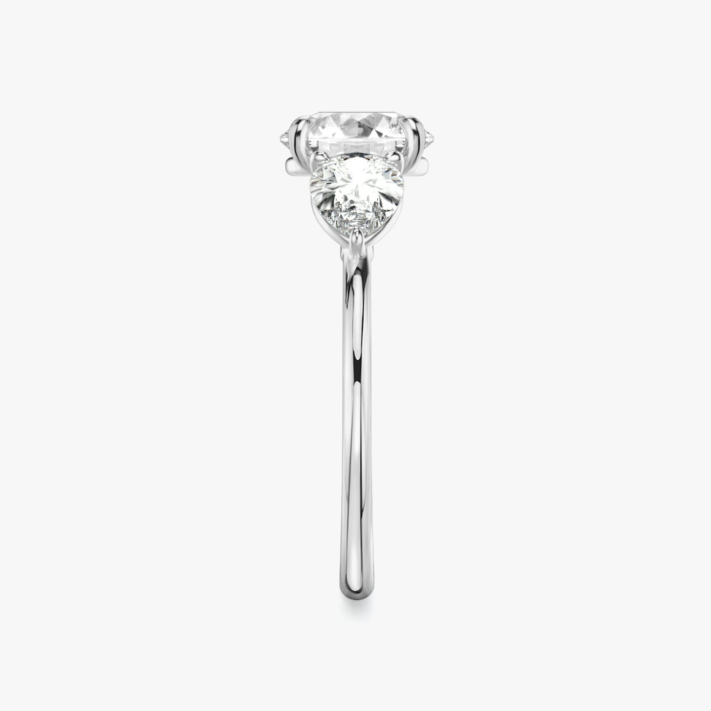 The Three Stone | Round Brilliant | Platinum | Band: Plain | Carat weight: See full inventory | Side stone carat: 1/2 | Side stone shape: Pear | Diamond orientation: vertical