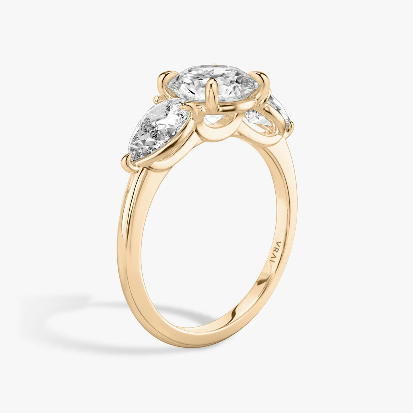 The Three Stone | Round Brilliant | 14k | 14k Rose Gold | Band: Plain | Carat weight: See full inventory | Side stone carat: 1/2 | Side stone shape: Pear | Diamond orientation: vertical