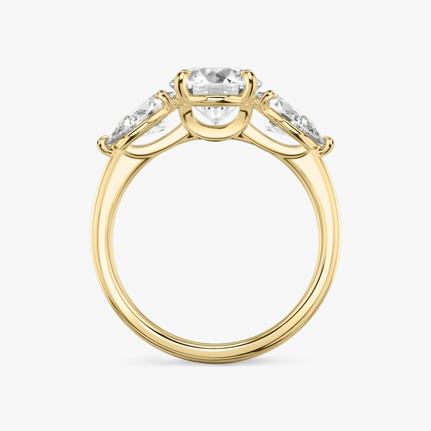 The Three Stone | Round Brilliant | 18k | 18k Yellow Gold | Band: Plain | Carat weight: See full inventory | Side stone carat: 1/2 | Side stone shape: Pear | Diamond orientation: vertical