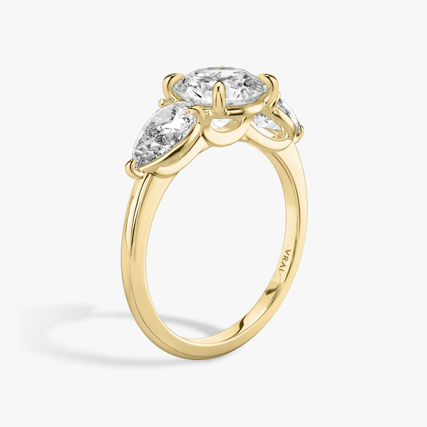 The Three Stone | Round Brilliant | 18k | 18k Yellow Gold | Band: Plain | Carat weight: See full inventory | Side stone carat: 1/2 | Side stone shape: Pear | Diamond orientation: vertical