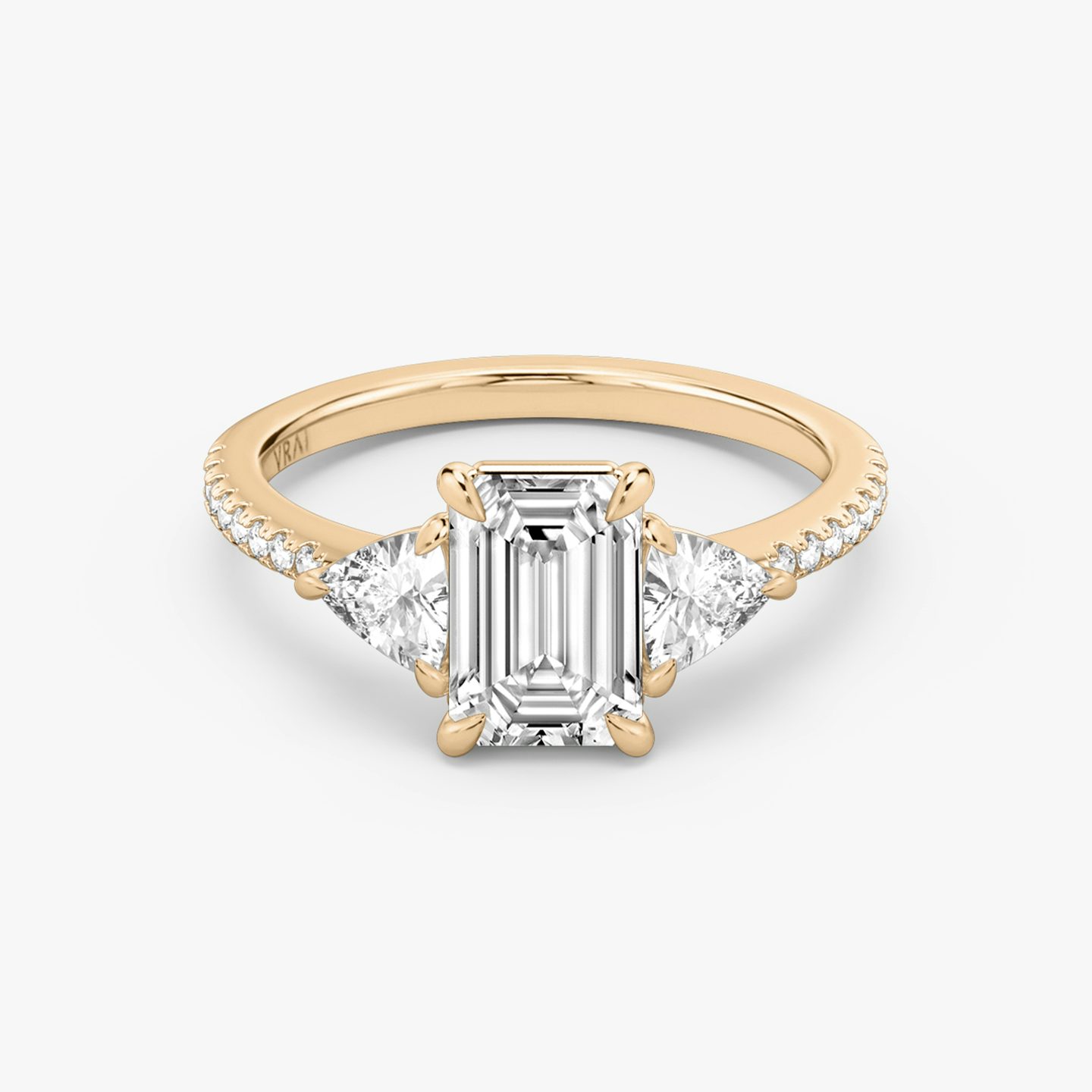The Three Stone | Emerald | 14k | 14k Rose Gold | Band: Pavé | Side stone carat: 1/4 | Side stone shape: Trillion | Diamond orientation: vertical | Carat weight: See full inventory
