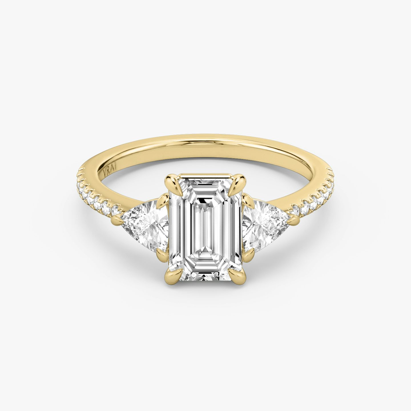 The Three Stone | Emerald | 18k | 18k Yellow Gold | Band: Pavé | Side stone carat: 1/4 | Side stone shape: Trillion | Diamond orientation: vertical | Carat weight: See full inventory