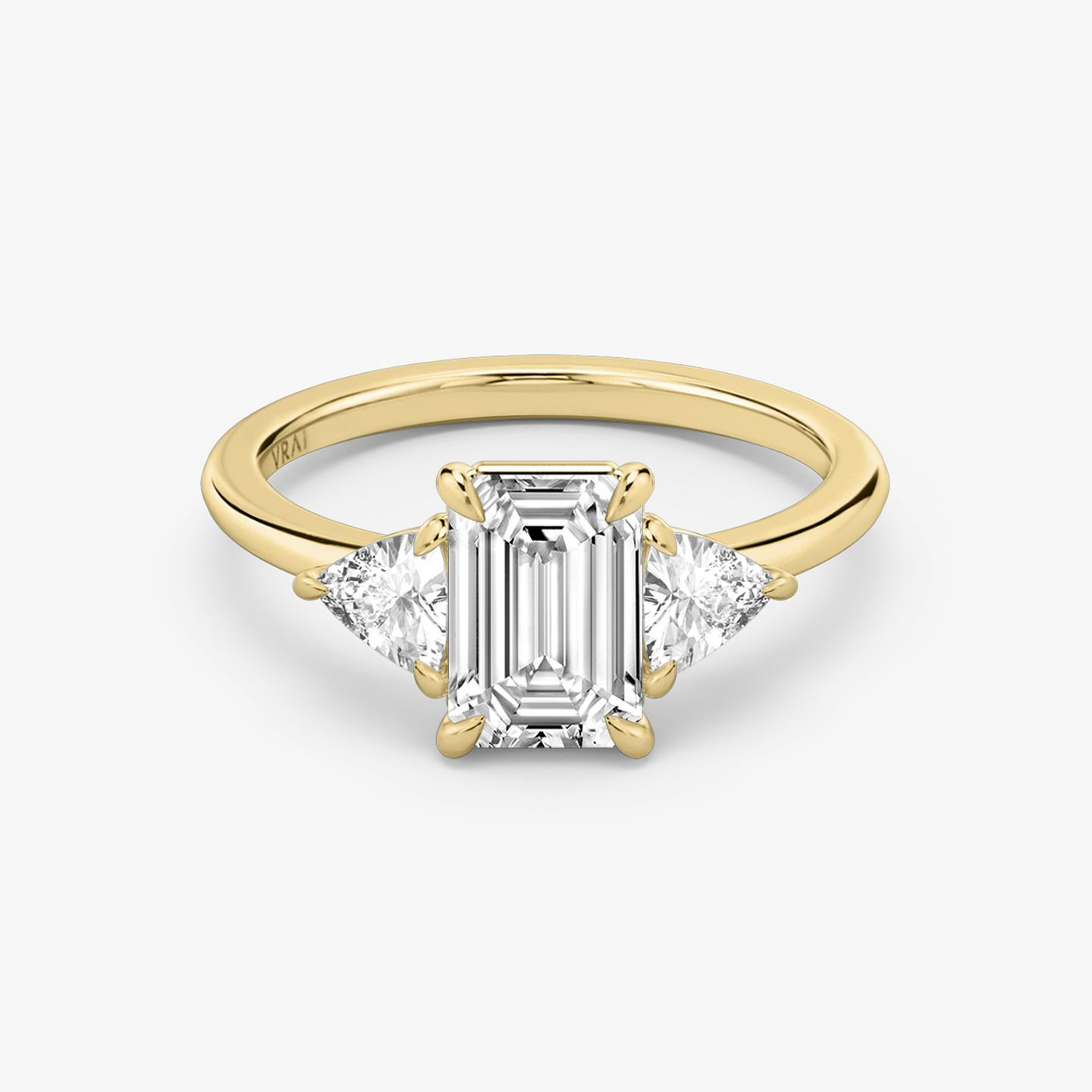 The Three Stone | Emerald | 18k | 18k Yellow Gold | Band: Plain | Side stone carat: 1/4 | Side stone shape: Trillion | Diamond orientation: vertical | Carat weight: See full inventory