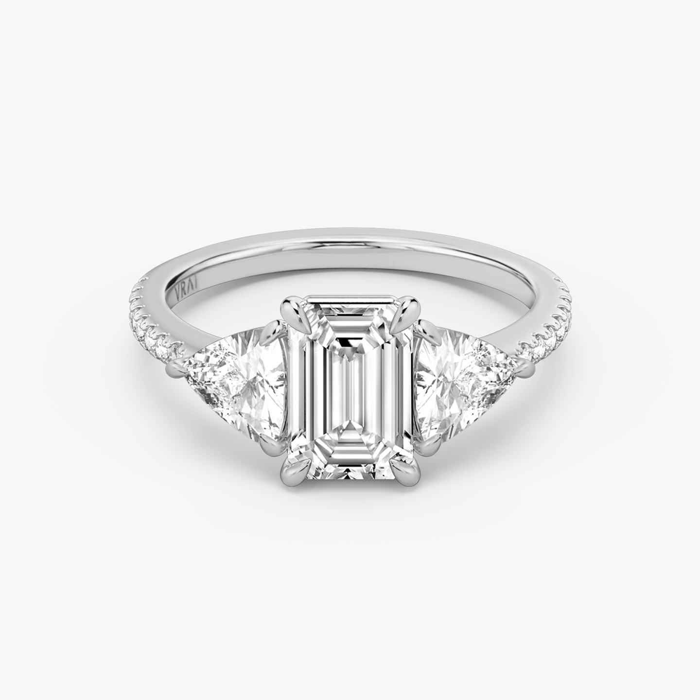 The Three Stone | Emerald | Platinum | Band: Pavé | Side stone carat: 1/2 | Side stone shape: Trillion | Diamond orientation: vertical | Carat weight: See full inventory