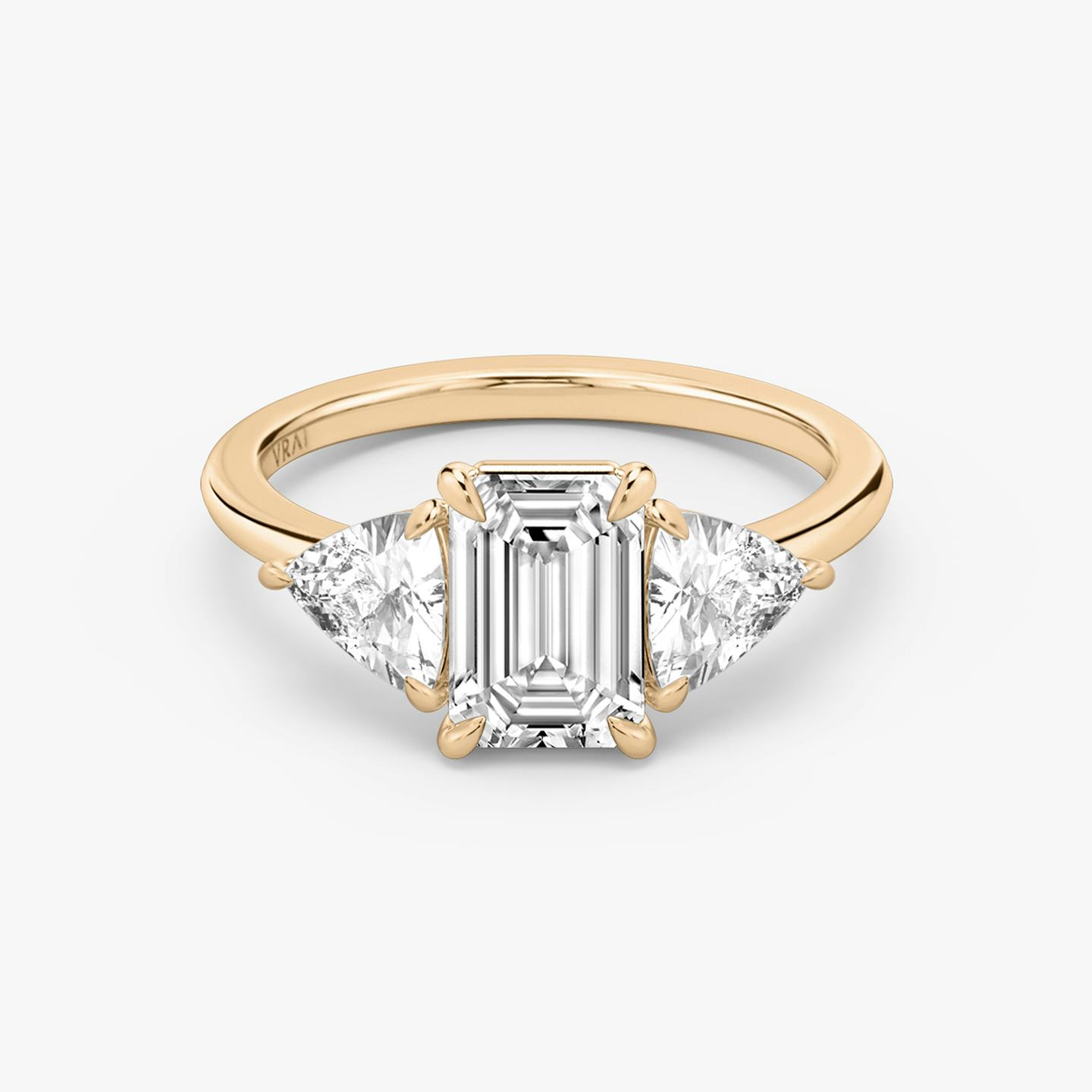 The Three Stone | Emerald | 14k | 14k Rose Gold | Band: Plain | Side stone carat: 1/2 | Side stone shape: Trillion | Diamond orientation: vertical | Carat weight: See full inventory