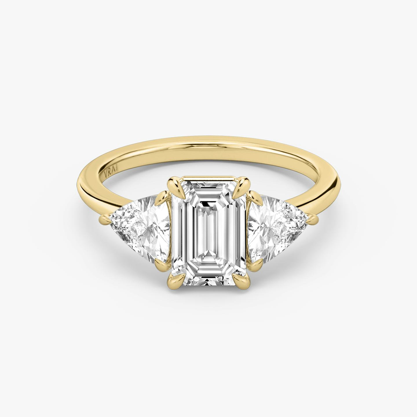 The Three Stone | Emerald | 18k | 18k Yellow Gold | Band: Plain | Side stone carat: 1/2 | Side stone shape: Trillion | Diamond orientation: vertical | Carat weight: See full inventory