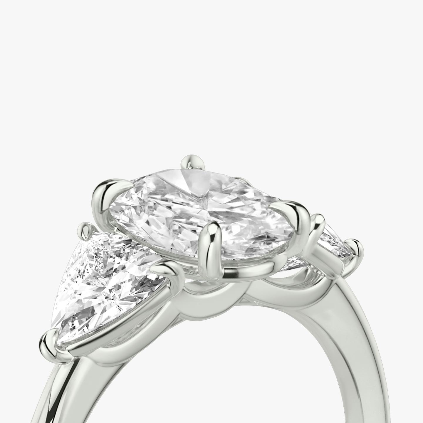 The Three Stone | Oval | 18k | 18k White Gold | Band: Plain | Side stone carat: 1/2 | Side stone shape: Trillion | Diamond orientation: vertical | Carat weight: See full inventory