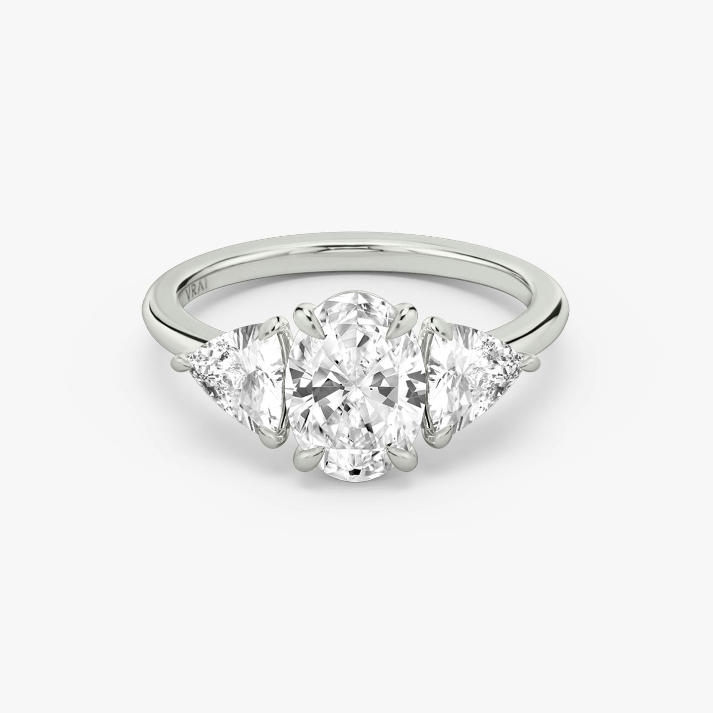 The Three Stone | Oval | 18k | 18k White Gold | Band: Plain | Side stone carat: 1/2 | Side stone shape: Trillion | Diamond orientation: vertical | Carat weight: See full inventory