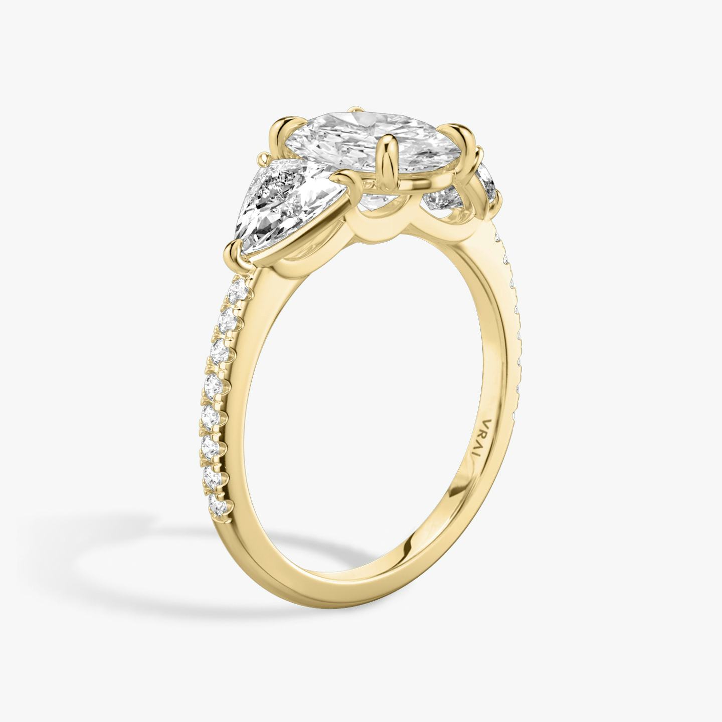 The Three Stone | Oval | 18k | 18k Yellow Gold | Band: Pavé | Side stone carat: 1/2 | Side stone shape: Trillion | Diamond orientation: vertical | Carat weight: See full inventory