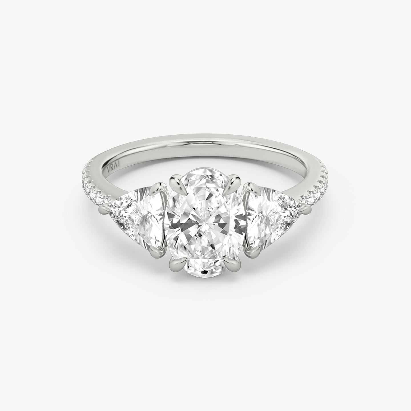 The Three Stone | Oval | 18k | 18k White Gold | Band: Pavé | Side stone carat: 1/2 | Side stone shape: Trillion | Diamond orientation: vertical | Carat weight: See full inventory