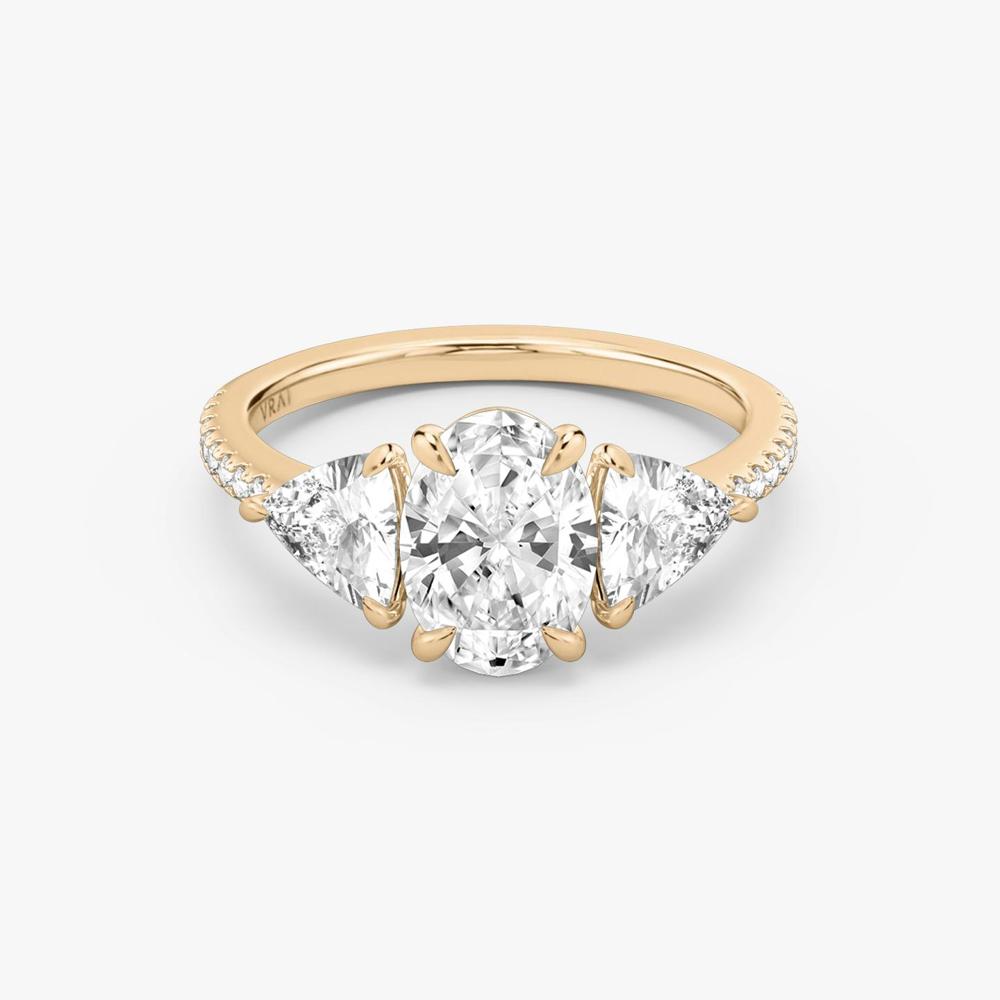 The Three Stone | Oval | 14k | 14k Rose Gold | Band: Pavé | Side stone carat: 1/2 | Side stone shape: Trillion | Diamond orientation: vertical | Carat weight: See full inventory