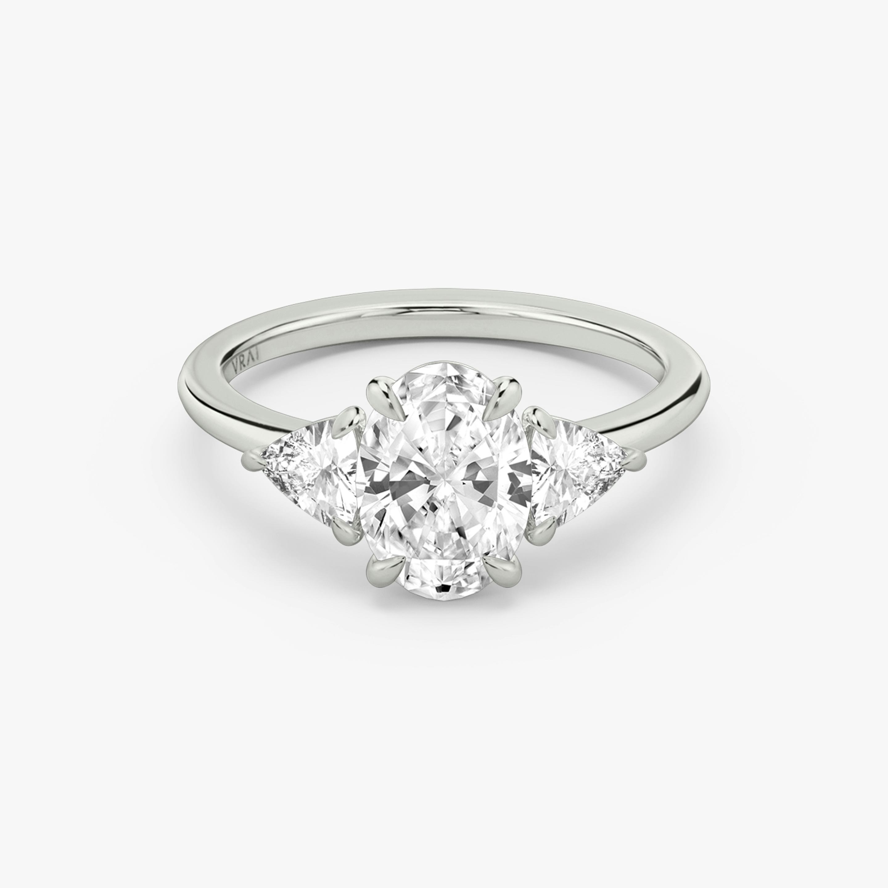 The Three Stone | Oval | Platinum | Band: Plain | Side stone carat: 1/4 | Side stone shape: Trillion | Diamond orientation: vertical | Carat weight: See full inventory