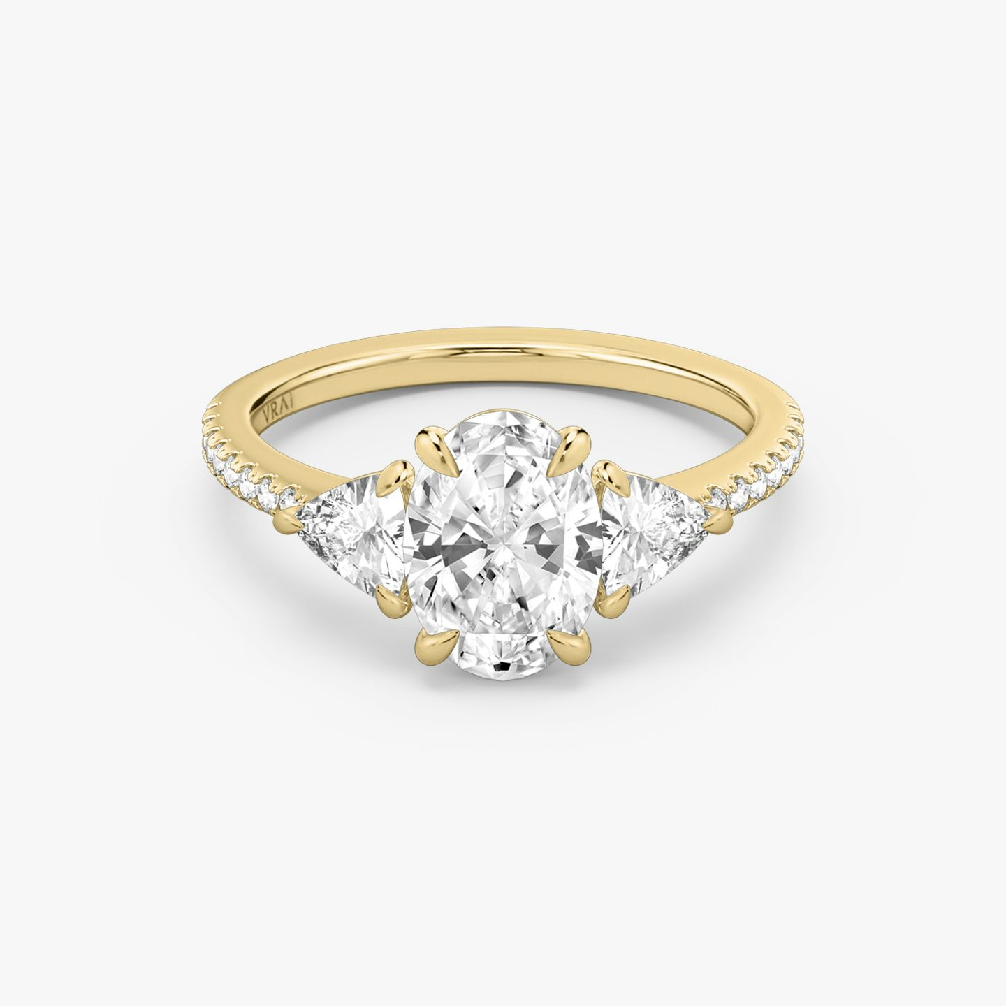 The Three Stone | Oval | 18k | 18k Yellow Gold | Band: Pavé | Side stone carat: 1/4 | Side stone shape: Trillion | Diamond orientation: vertical | Carat weight: See full inventory
