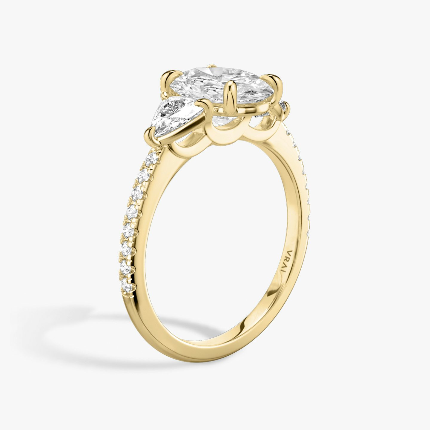 The Three Stone | Oval | 18k | 18k Yellow Gold | Band: Pavé | Side stone carat: 1/4 | Side stone shape: Trillion | Diamond orientation: vertical | Carat weight: See full inventory