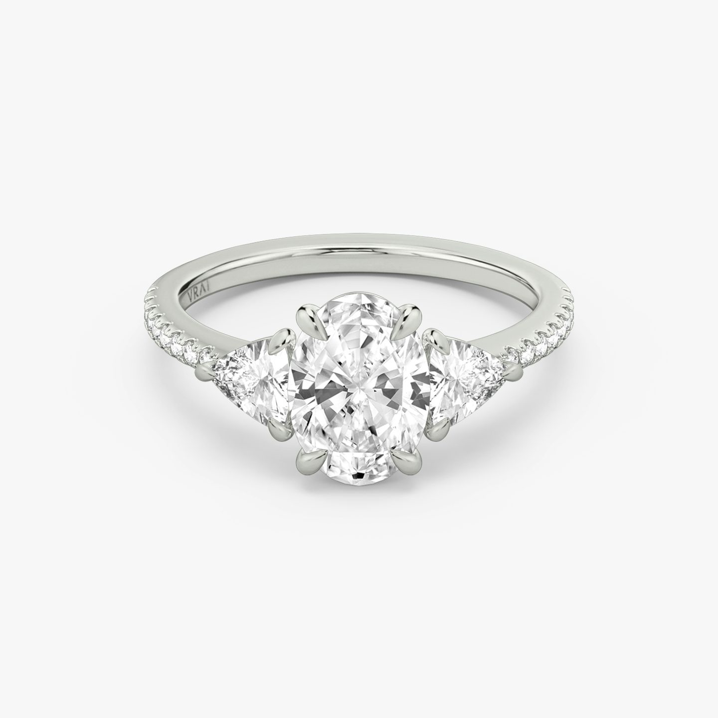 The Three Stone | Oval | 18k | 18k White Gold | Band: Pavé | Side stone carat: 1/4 | Side stone shape: Trillion | Diamond orientation: vertical | Carat weight: See full inventory