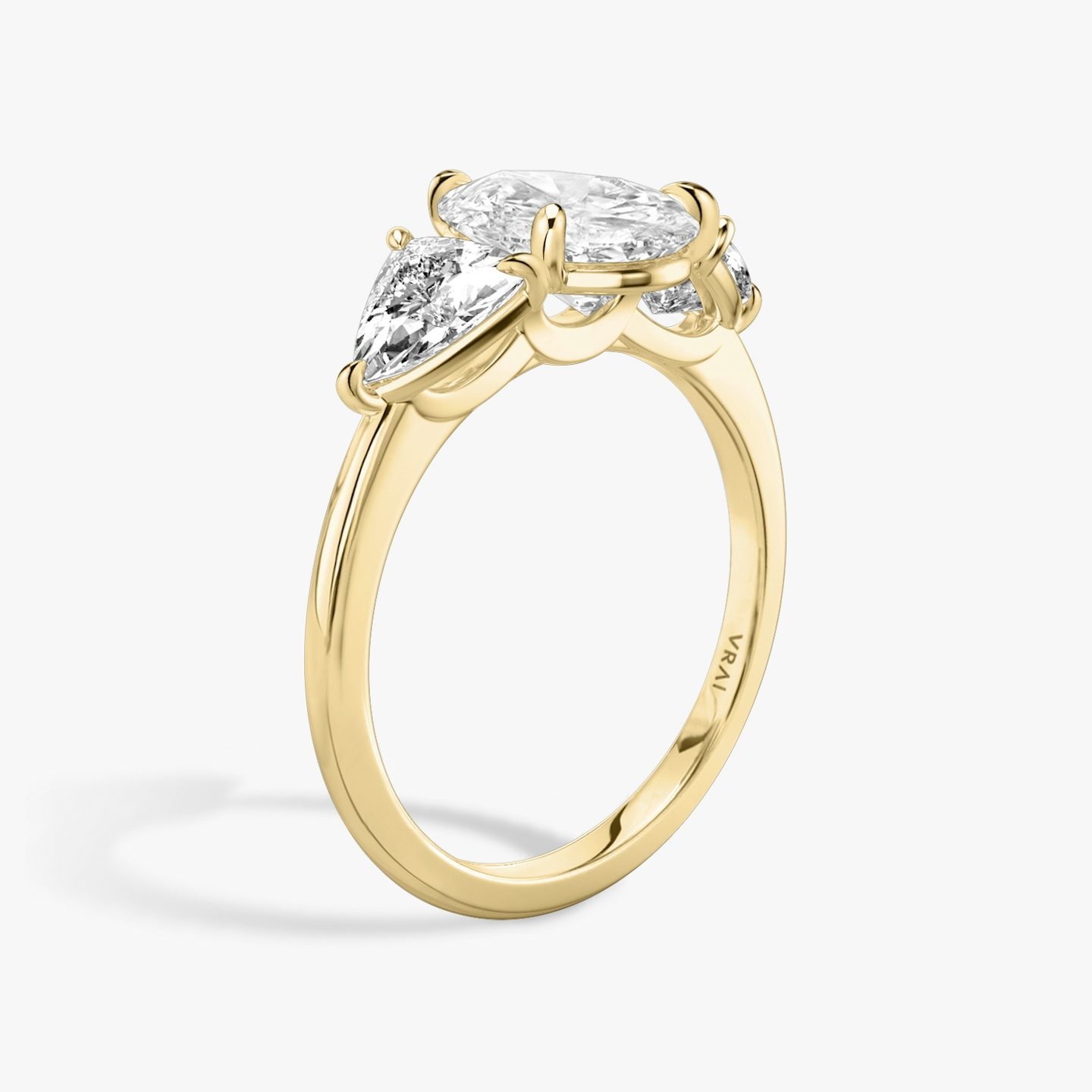 The Three Stone | Pear | 18k | 18k Yellow Gold | Band: Plain | Side stone carat: 1/2 | Side stone shape: Trillion | Diamond orientation: vertical | Carat weight: See full inventory