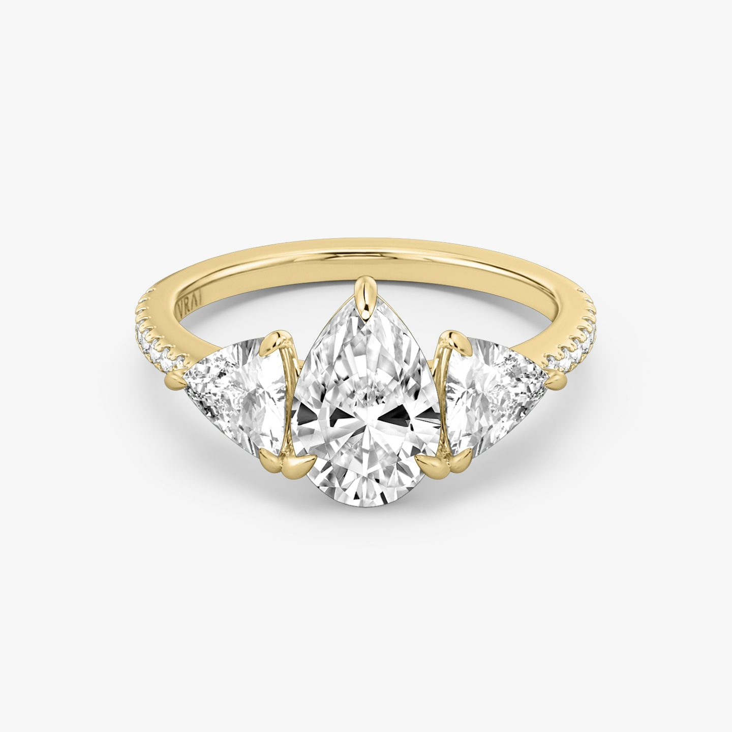 The Three Stone | Pear | 18k | 18k Yellow Gold | Band: Pavé | Side stone carat: 1/2 | Side stone shape: Trillion | Diamond orientation: vertical | Carat weight: See full inventory